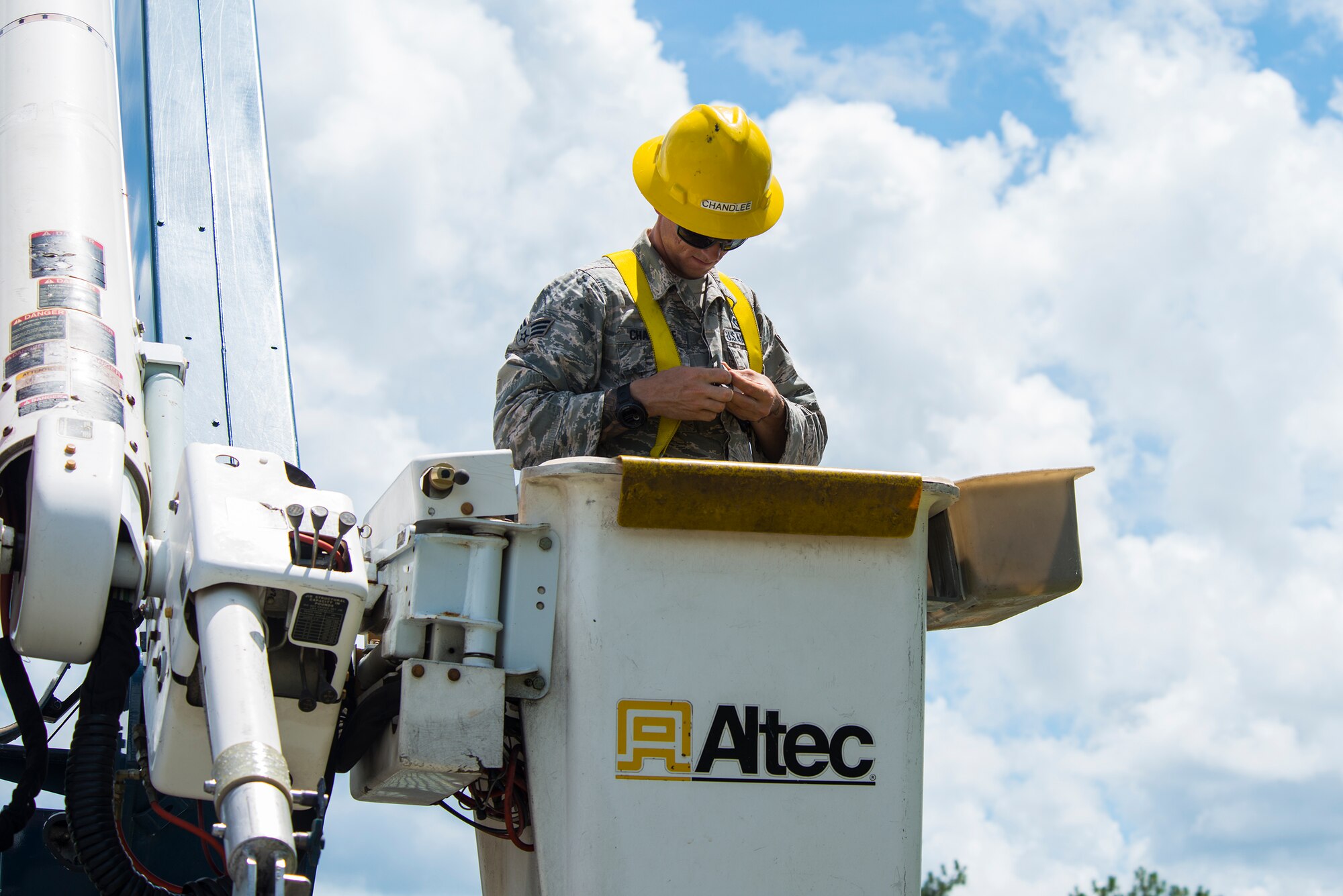 U.S. Air Force Senior Airman Richard Chandlee, 23d Civil Engineer Squadron electrical systems specialist, adjusts his harness Aug. 17, 2015, at Moody Air Force Base, Ga. Chandlee used an aerial lift truck to assist in installing a street light. (U.S. Air Force photo by Airman 1st Class Ceaira Tinsley/Released)