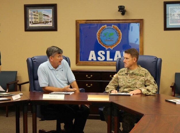 Colonel Stephen Riley, Surface Deployment and Distribution Command, 597th Transportation Brigade commander and Robert O'Brien, Army Strategic Logistics Activity Charleston general manager discuss the ASLAC mission Aug 6, 2015 during a tour of the ASLAC facility in Charleston, S.C. Riley, along with Lt. Col. Dennis Major, SSDC, 841st Transportation Battalion toured Wharf A, ASLAC (APS-3), the Wando Terminal and the North Charleston Terminal. (Courtesy Photo / 841st Transportation Battalion / 597th Transportation Brigade) 