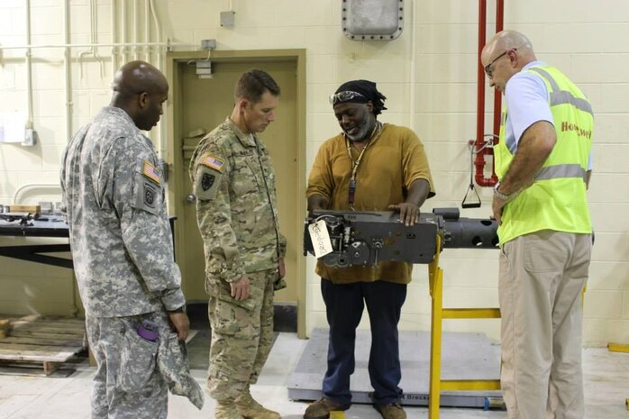 Lieutenant Colonel Dennis Major, Surface Deployment and Distribution Command, 841st Transportation Battalion command (left) and Col. Stephen Riley, SDDC, 597th Transportation Brigade commander observe a demonstration on the maintenance Army Strategic Logistics Activity Charleston performs on guns such as the M242A1 Bushmaster chain gun for the Bradley family of vehicles Aug 6, 2015 during a tour of the ASLAC facility in Charleston, S.C. (Courtesy Photo / 841st Transportation Battalion / 597th Transportation Brigade) 