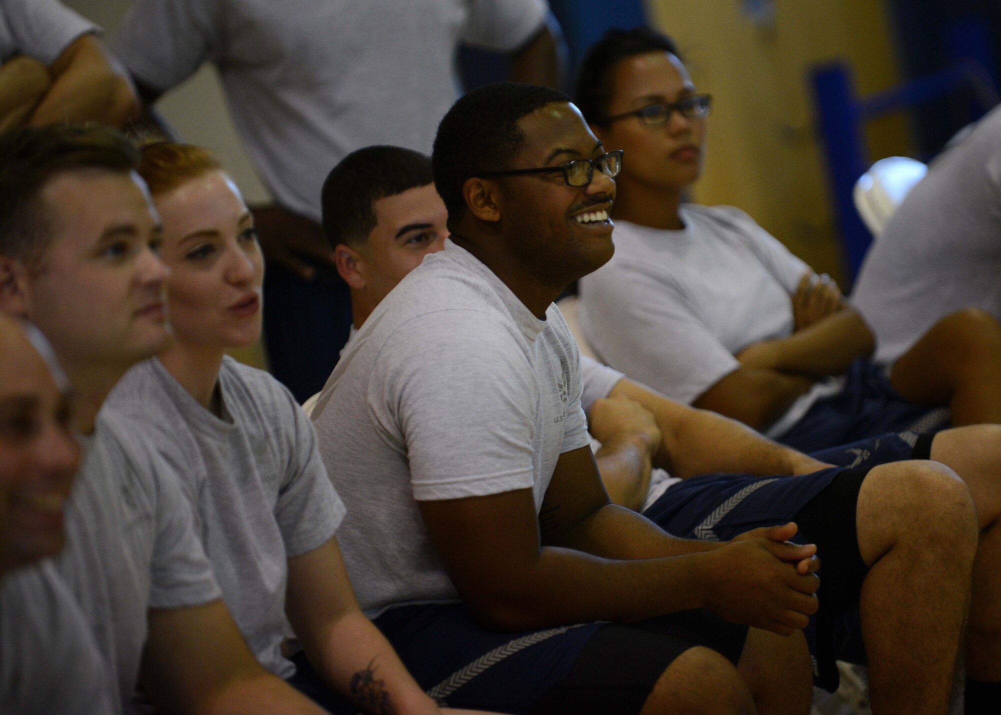 U.S. Air Force Senior Airman Kerwin Thomas, 31st Maintenance Squadron electronics and environmental specialist, and Airman Leadership School students watch a volleyball match, Aug. 17, 2015, at Aviano Air Base, Italy. The matches provided morale and a chance for friendly competition between leadership and the students. (U.S. Air Force photo by Staff Sgt. Evelyn Chavez /Released)