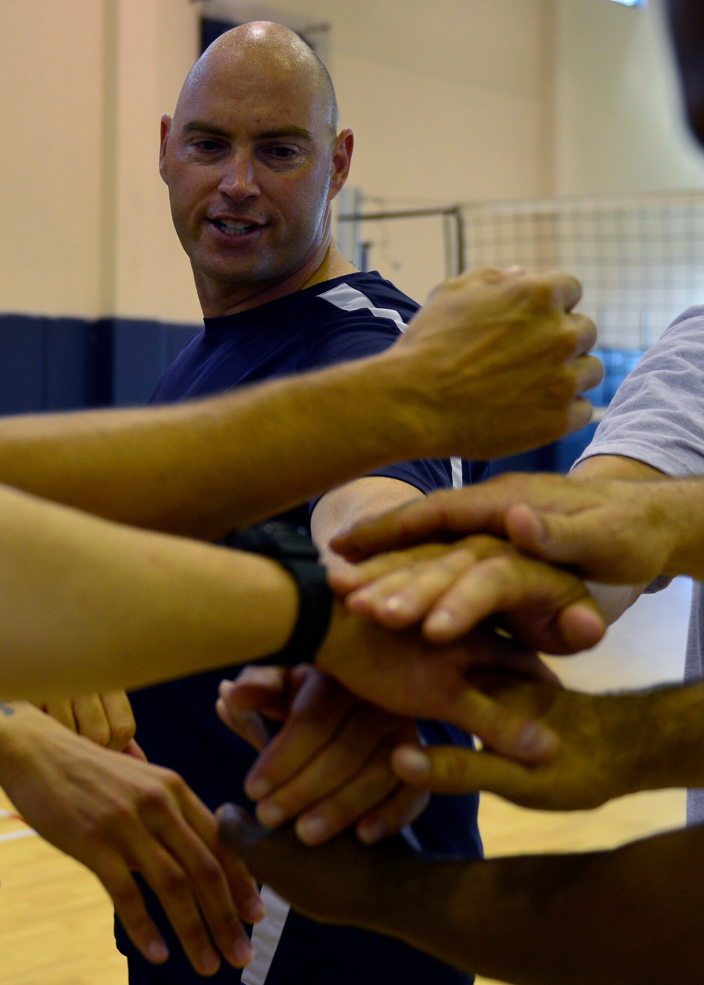 U.S. Air Force Master Sgt. Vincent Brass, 31st Logistics Readiness Squadron first sergeant, celebrates with his teammates after defeating Airman Leadership School in the final volleyball match, Aug. 17, 2015, at Aviano Air Base, Italy. The senior enlisted team brought home bragging rights after winning the four-game tournament. (U.S. Air Force photo by Airman 1st Class Cary Smith/Released)
