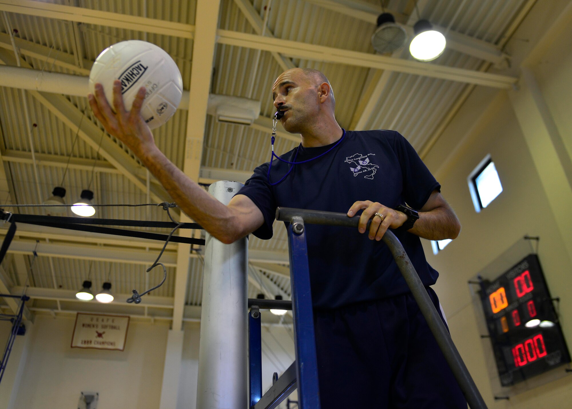 U.S. Air Force Master Sgt. Jose Negron, Airman Leadership School commandant, throws a ball into play during an ALS volleyball match, Aug. 14, 2015, at Aviano Air Base, Italy. ALS classes play base leadership in friendly volleyball matches, which provided interaction with leadership outside normal work environments. (U.S. Air Force photo by Airman 1st Class Cary Smith/Released)