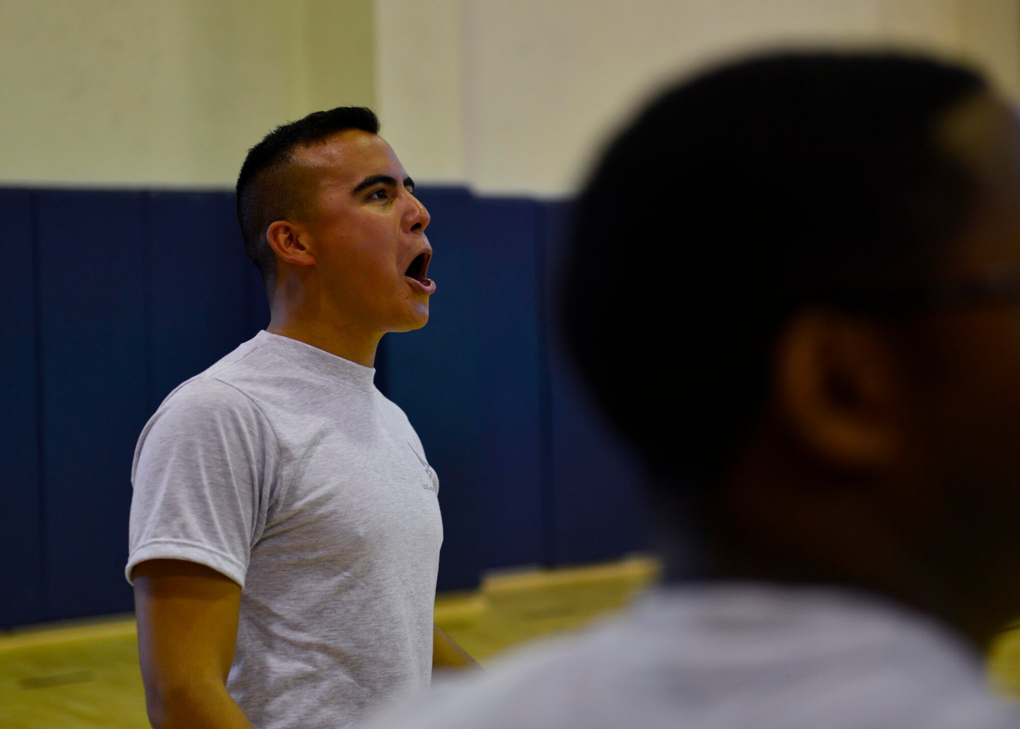 U.S. Air Force Senior Airman Jorge Gallardo, 31st Aircraft Maintenance Squadron avionics specialist, cheers for his teammates during an Airman Leadership School volleyball match, Aug. 14, 2015, at Aviano Air Base, Italy. The matches provided morale and a chance for friendly competition between leadership and the students. (U.S. Air Force photo by Airman 1st Class Cary Smith/Released)