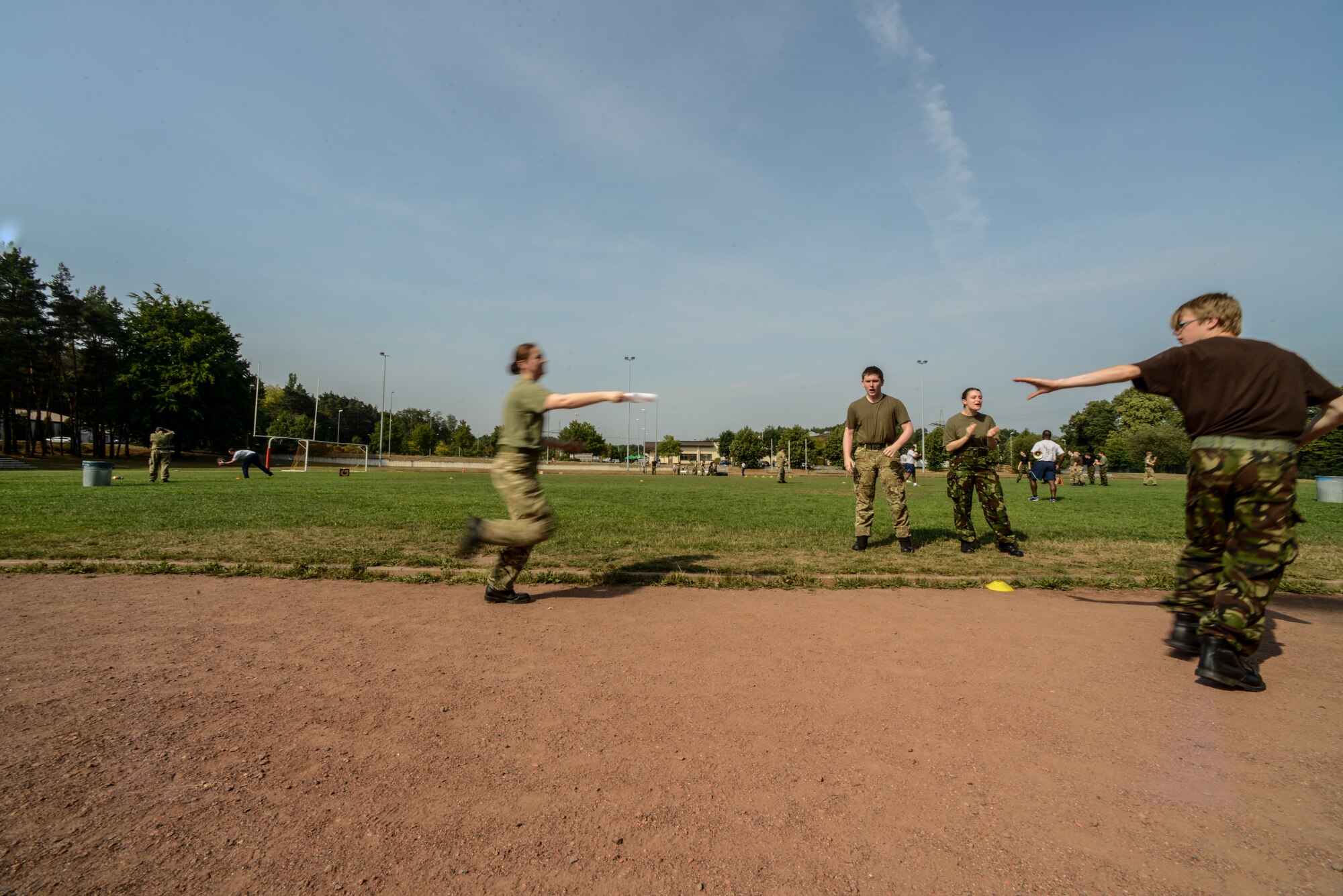 Royal Air Force Air Training Corps cadets pass a baton during an obstacle course Aug. 10, 2015, on Vogelweh, Germany.  The RAF air cadets visited the Kisling NCO Academy for a two-day team-building course which not only gave them a glimpse of U.S. military life, but also strengthened the alliance between the NATO partners. (U.S. Air Force photo/Senior Airman Nicole Sikorski)