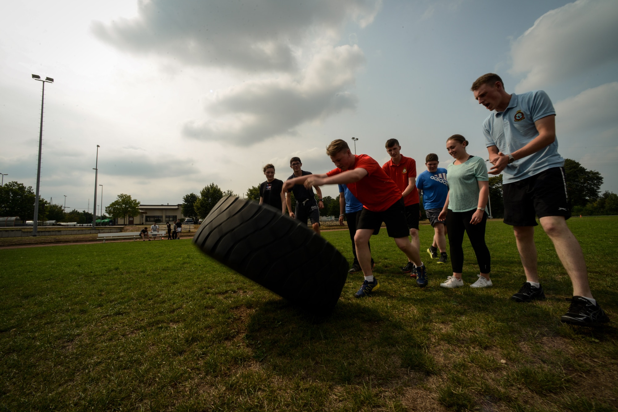 Royal Air Force Air Training Corps cadets work as a team to move a tire across a football field Aug. 10, 2015, on Vogelweh, Germany. The cadets participated in a two-day course at the Kisling NCO Academy, which focused on teamwork and allowed them to experience day-to-day life in the U.S. military. (U.S. Air Force photo/Senior Airman Nicole Sikorski) 
