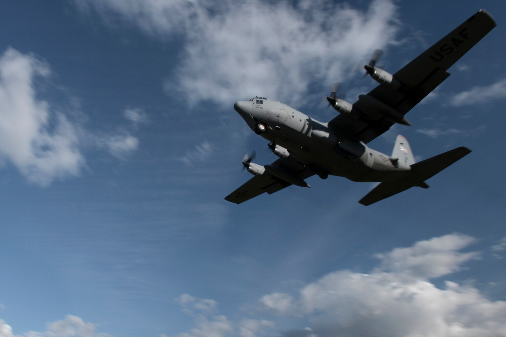 A C-130 Hercules with the 36th Airlift Squadron from Yokota Air Base, Japan, takes off of an austere runway used for training during RED FLAG-Alaska at Joint Base Elmendorf-Richardson, Alaska, Aug. 14, 2015. The training allowed C-130 aircrew to practice austere landings and take offs, combat offloads and supply drops, but also allowed friendly competition between participating Air Forces: U.S. Air Force, Japan Air Self-Defense Force, Royal Air Force, Royal Australian Air Force, Royal New Zealand Air Force and Royal Thai Air Force. Seasoned C-130 aircrew from each country judged the training exercises from the ground, allotting points based off predetermined timing and accuracy requirements. (U.S. Air Force photo by Staff Sgt. Cody H. Ramirez/Released)