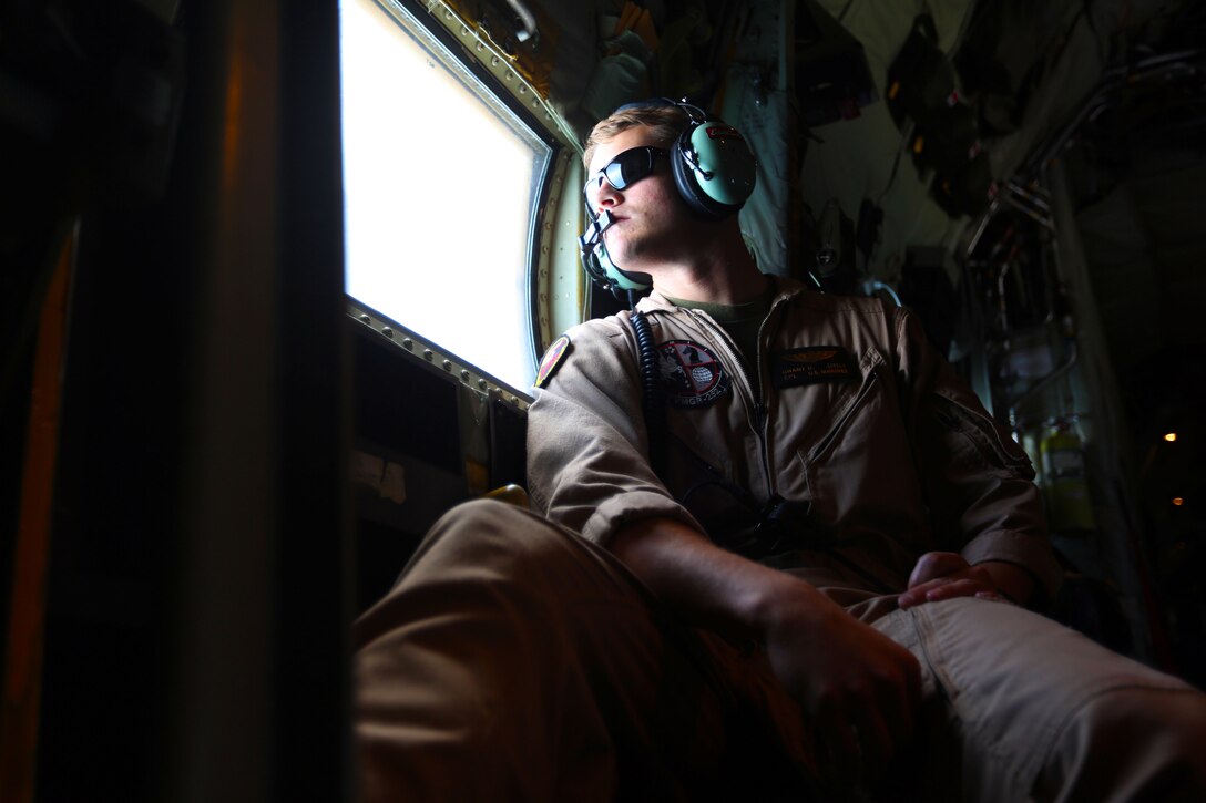 Cpl. Grant Little scans the horizon for aproaching aircraft during aerial refueling training near Marine Corps Air Station Beaufort, South Carolina, Aug. 13, 2015. Marine Aerial Refueler Transport Squadron 252’s mission is to is to support the Marine Air-Ground Task Force commander by providing air-to-air refueling, assault support, and offensive air support, day or night under all weather conditions during expeditionary, joint, or combined operations. VMGR-252 is based out of Marine Corps Air Station Cherry Point, North Carolina. Little is a crew master with the squadron. (U.S. Marine Corps photo by Cpl. N.W. Huertas/Released)
