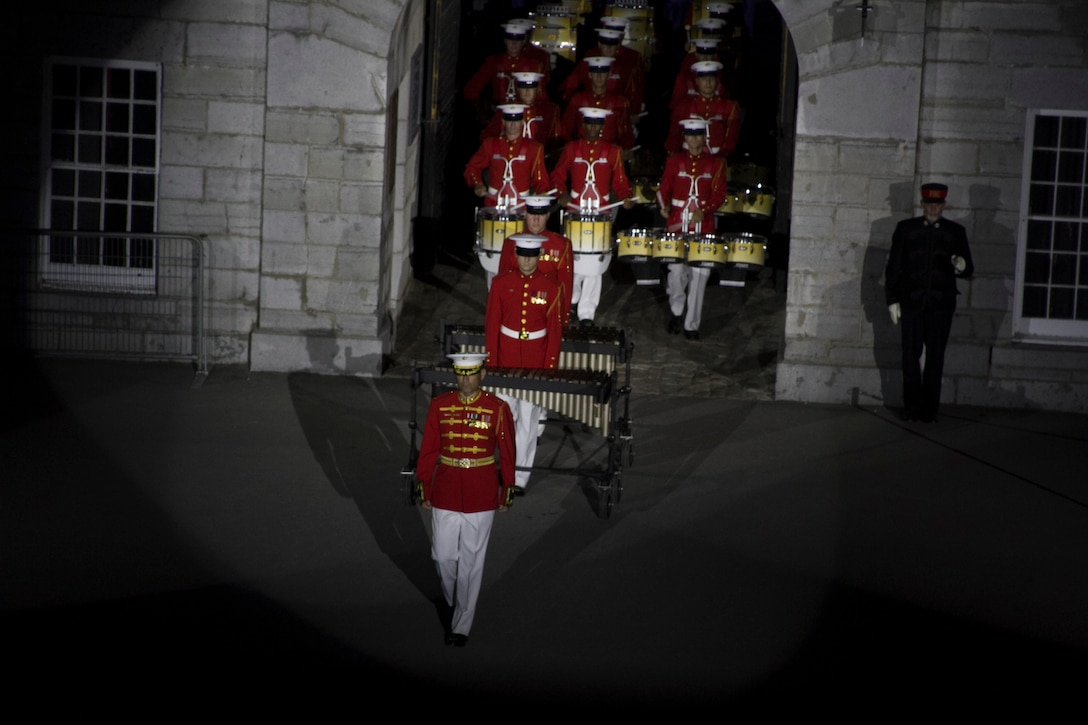 The United States Marine Drum and Bugle Corps perform during a joint ceremony with the Fort Henry Guard at Kingston, Ontario, Canada, Aug. 16, 2015. The relationship between the Marines and Fort Henry goes back 61 years to 1954 when the Marines first visited the Fort. This visit marked the anniversary of the Ogdensburg Agreement, which was signed by President Roosevelt and Prime minister King to bind the two nations in the joint defense of North America. Since that time, the two units have paraded together countless times both at the Fort and at Marine Barracks Washington, D.C. (U.S. Marine Corps photo by Cpl. Skye Davis/Released)