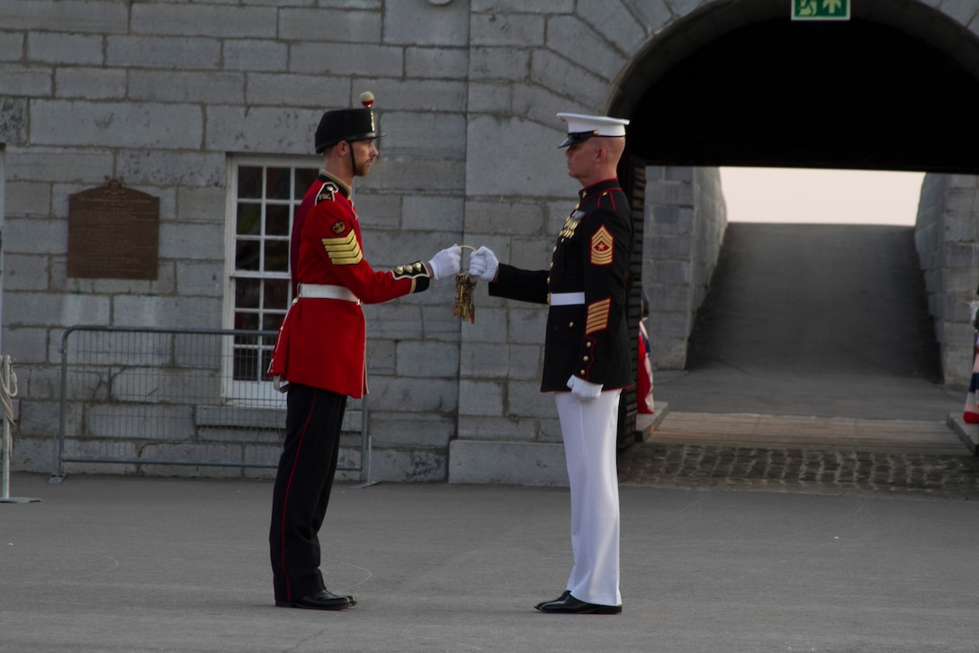 The Sergeants Maj. of the Fort Henry Guard and Marine Barracks Washington, D.C., conduct the key exchange to the Fort during a joint ceremony at Kingston, Ontario, Canada, Aug. 17, 2015. The relationship between the Marines and Fort Henry goes back 61 years to 1954 when the Marines first visited the Fort. This visit marked the anniversary of the Ogdensburg Agreement, which was signed by President Roosevelt and Prime minister King to bind the two nations in the joint defense of North America. Since that time, the two units have paraded together countless times both at the Fort and at Marine Barracks Washington, D.C. (U.S. Marine Corps photo by Cpl. Skye Davis/Released)