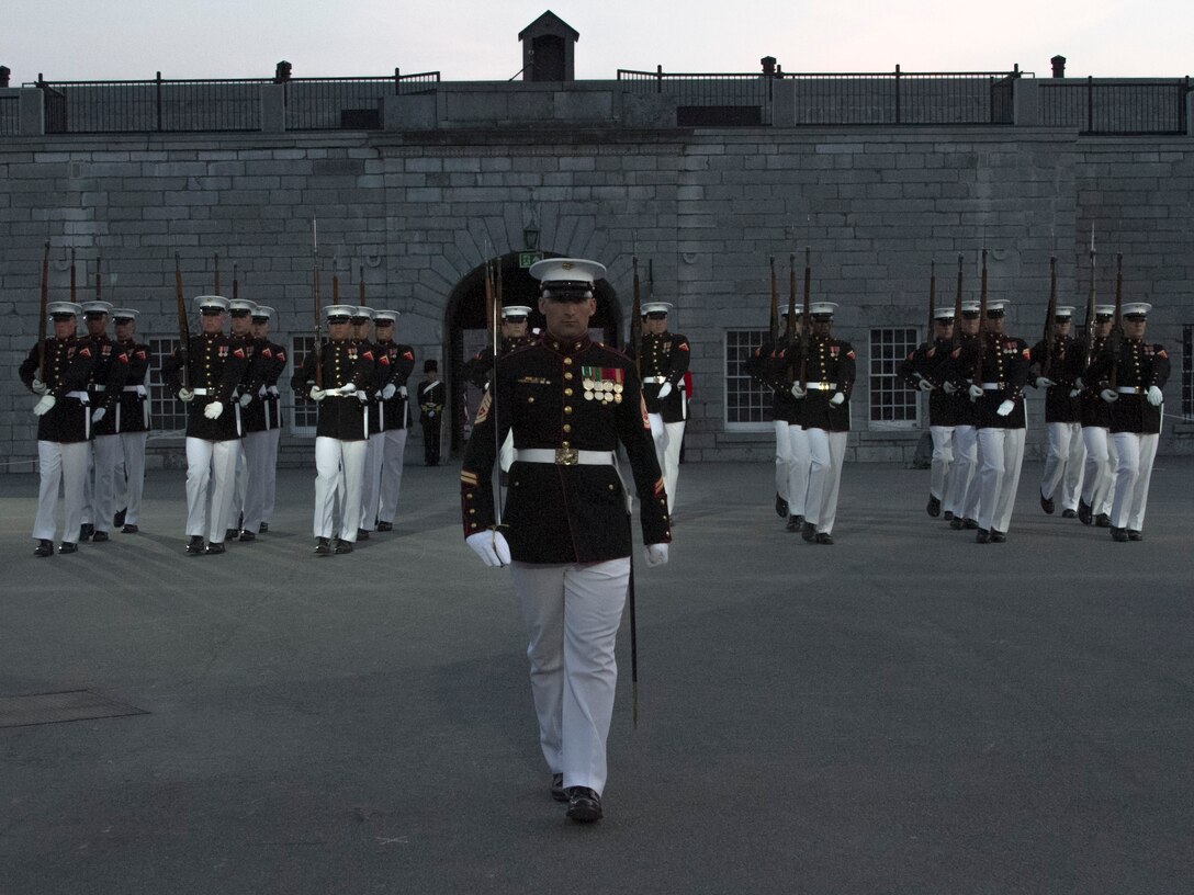 The Silent Drill Platoon performs during a joint ceremony with the Fort Henry Guard at Kingston, Ontario, Canada Aug. 17, 2015. The relationship between the Marines and Fort Henry goes back 61 years to 1954 when the Marines first visited the Fort. This visit marked the anniversary of the Ogdensburg Agreement, which was signed by President Roosevelt and Prime Minister King to bind the two nations in the joint defense of North America. Since that time, the two units have paraded together countless times both at the Fort and at Marine Barracks Washington. (U.S. Marine Corps photo by Cpl. Skye Davis/Released)