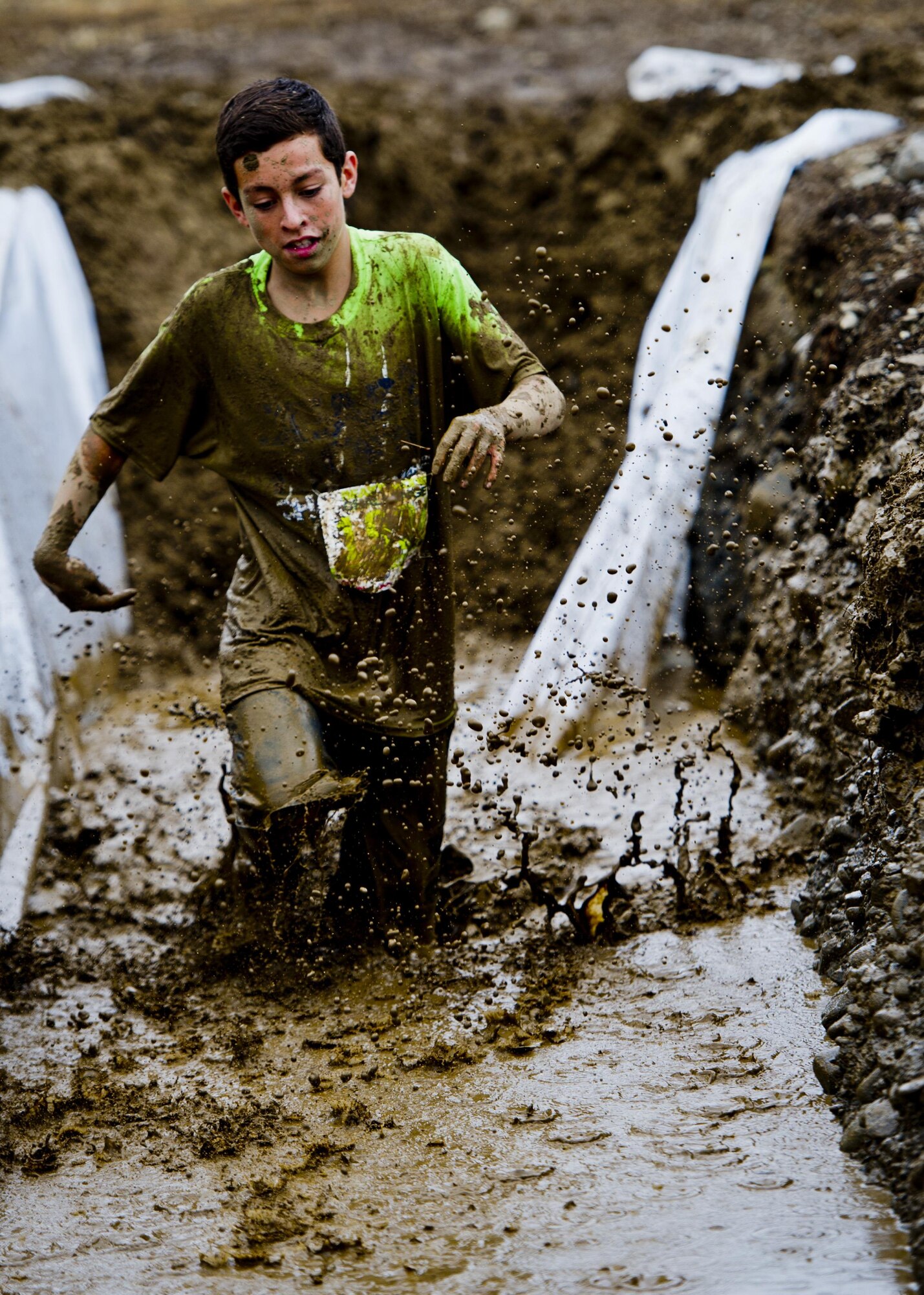 A participant in the Beast Mode Challenge sponsored by the Air Force Reserve, races through an obstacle course in Snoqualmie, Wash., Aug. 15, 2015. The challenge was composed of a 3.5-mile mud-ridden obstacle course - with 12 football-themed trials of hills, blockades, water, and sludge, created to trigger one's inner Beast Mode. A portion of the race proceeds and 100% of donations went directly to the Fam 1st Family Foundation co-founded by Marshawn ‘Beast Mode’ Lynch of the Seattle Seahawks. The Fam 1st Family Foundation is dedicated to uplifting and empowering youth in the Bay Area and throughout the United States. The foundation’s mission is one of empowerment and education,aiming to build self-esteem and academic learning skills in underprivileged youth. (U.S. Air Force photo/Senior Airman Daniel Liddicoet)