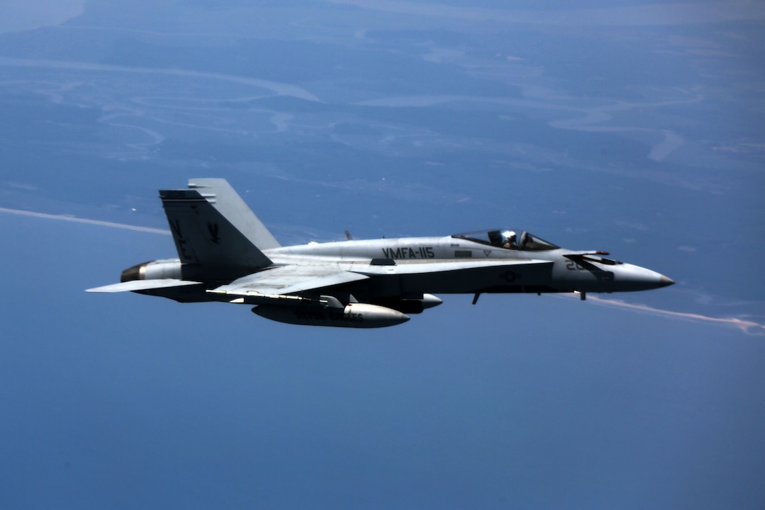 An F/A-18 Hornet conducts aerial maneuvers during aerial refueling training over the Atlantic Ocean, Aug. 13, 2015. Marine Fighter Attack Squadron 115’s mission it to intercept and destroy enemy aircraft under all-weather conditions and attack and destroy surface targets. VMFAT-115 is based out of Marine Corps Air Station Beaufort, South Carolina. (U.S. Marine Corps photo by Cpl. N.W. Huertas/Released)