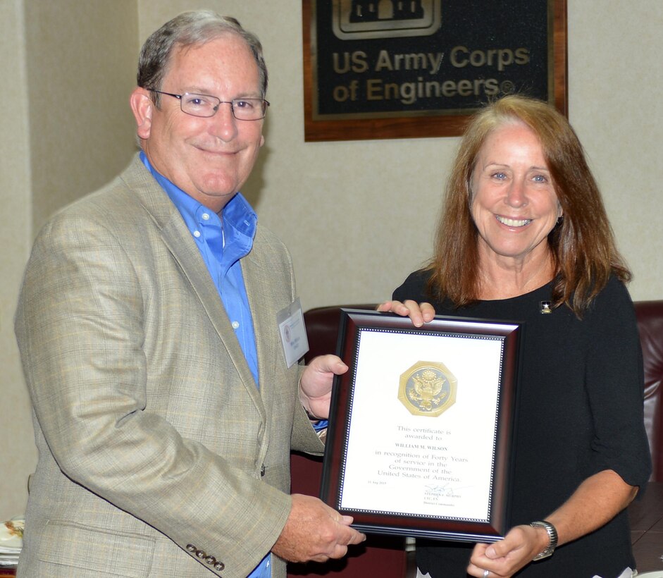 The Honorable Jo-Ellen Darcy, assistant secretary of the Army for Civil Works, presents Mike Wilson, U.S. Army Corps of Engineers Nashville District deputy for Programs and Project Management, with a certificate recognizing his 40 years of service during a stakeholder meeting with the Mississippi River Commission onboard the Motor Vessel Mississippi while docked in Clarksville, Tenn., Aug. 11, 2015. 