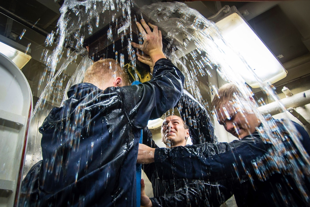 U.S. Navy Petty Officers 3rd Class Jon Hawkins and Jake Hojnowski, and Seaman Leslie Carlsonbeltz install shoring in a wet trainer on the aircraft carrier USS John C. Stennis in the Pacific Ocean, Aug. 17, 2015. The carrier uses the wet trainer to prepare its crew for fighting shipboard casualties. U.S. Navy photo by Petty Officer 3rd Class Jonathan Jiang