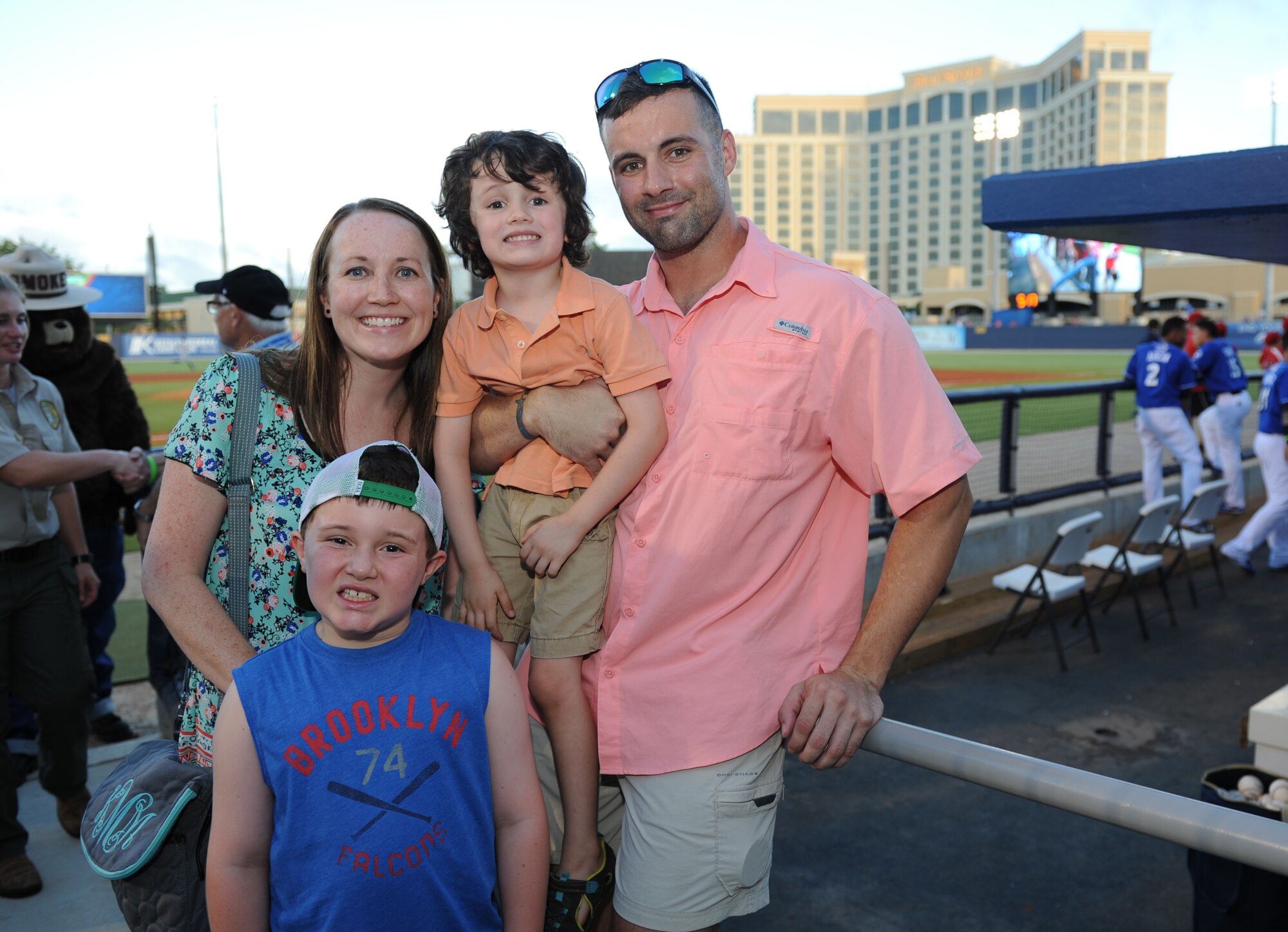 Staff Sgt. Jonathan McMillan, 81st Diagnostic and Therapeutics Squadron cat scan NCOIC, poses for a photo with his wife, Katie, son, Weston, and his nephew, Brandon Lakes, during a Biloxi Shuckers Minor League Baseball game Aug. 15, 2015, at MGM Park, Biloxi, Miss. Weston threw an opening pitch prior to the start of the game. (U.S. Air Force photo by Kemberly Groue)
