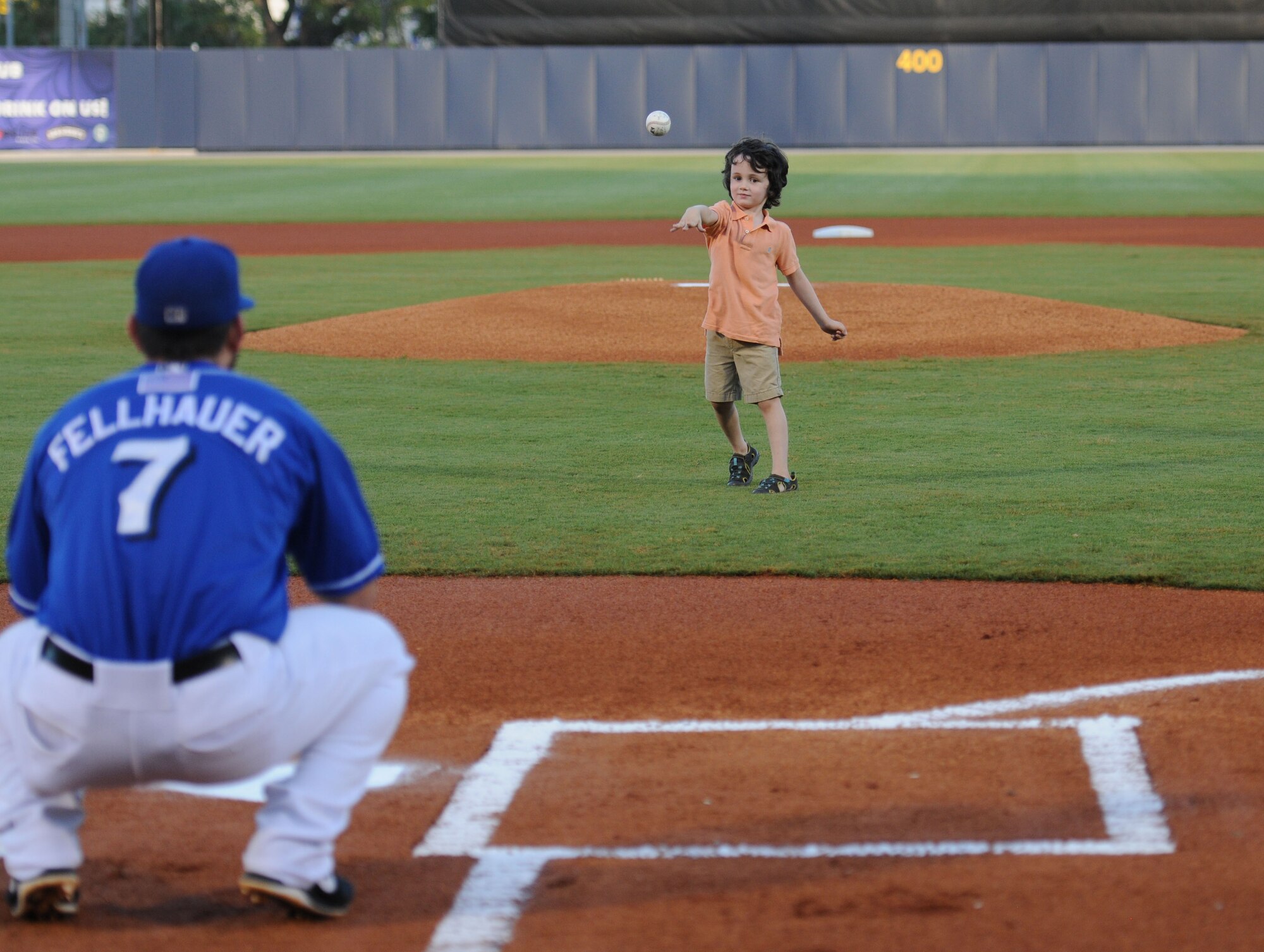 Weston McMillan, son of Staff Sgt. Jonathan McMillan, 81st Diagnostic and Therapeutics Squadron cat scan NCOIC,, throws an opening pitch prior to the start of the Biloxi Shuckers Minor League Baseball game Aug. 15, 2015, at MGM Park, Biloxi, Miss. Col. Michele Edmondson, 81st Training Wing commander, also threw an opening pitch during the event.  (U.S. Air Force photo by Kemberly Groue)