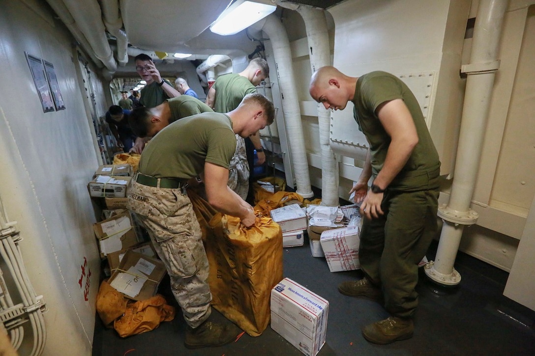 GULF OF ADEN (Aug. 15, 2015) U.S. Marines with the 15th Marine Expeditionary Unit help sort mail received from the USNS John Ericsson (T-AO 194) during a replenishment-at-sea. The 15th Marine Expeditionary Unit is embarked aboard the amphibious transport dock ship USS Anchorage (LPD 23), part of the Essex Amphibious Ready Group, and is deployed in support of maritime security operations and theater security cooperation efforts in the U.S. 5th Fleet area of operations. (U.S. Marine Corps photo by Sgt. Steve H. Lopez/ Released)