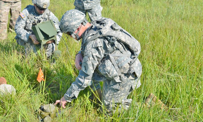 Spc. Isaac Robledo (left) and Pvt. Greggory Savage, both combat engineers with Company B, 1st Bde. Eng. Bn., 1st ABCT, 1st Inf. Div., practice arming and disarming the M-7 Spider Landmine July 31 at Range 7 on Fort Riley, Kan. The Spider is an anti-personnel networked munitions system that can be securely commanded and controlled from up to 1,500 meters away that will replace anti-personnel mines.
