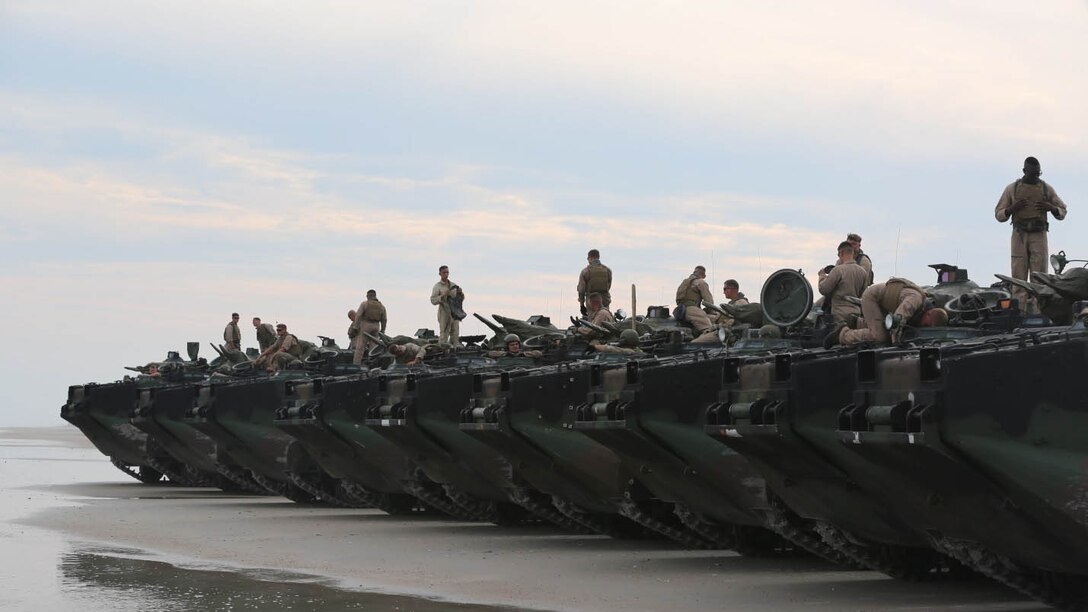 Marines with 1st Platoon, Bravo Company, 2nd Assault Amphibian Battalion wait for the final check of their amphibious assault vehicles and then go ahead to conduct their training exercise on Onslow Beach aboard Camp Lejeune N.C. Aug. 17, 2015. Doing a double check of the AAVs is paramount for safety in making sure everything is in working order.