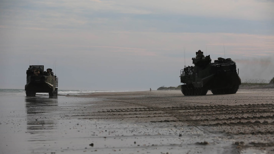 Two amphibious assault vehicles with 1st Platoon, Bravo Company, 2nd Assault Amphibian Battalion make their way back to the starting point of their beach assault exercise on Onslow Beach aboard Camp Lejeune, N.C. Aug. 17, 2015. AAVs are made for the purpose of going from ship to shore and back with ease.