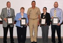 DAHLGREN, Va. - NSWC Dahlgren Division awardees Christopher Nerney, Donna Wheater, Melanie Lunney and David Luck, l to r, are pictured with Vice Adm. William Hilarides, commander, Naval Sea Systems Command, moments after the admiral presented them with letters of appreciation at an Aug. 11 awards ceremony. Hilarides commended the team, including Michael Clark and Adrienne Phaler, for supporting the Cybersecurity Technical Exchange Meeting sponsored by NAVSEA. "This meeting brought together leaders from Naval Sea Systems Command, Naval Air Systems Command, Space and Naval Warfare Systems Command, and United States Tenth Fleet in one place to discuss and 'connect the dots' pertaining to cyber-related work spanning the Navy enterprise," said Hilarides in the letter. "Your behind the scenes involvement in this technical exchange was paramount, enabling both current and future cyber deliberations that are of the highest importance to the Navy." Describing the accomplishment as "a major milestone in charting Naval Sea Systems Command's way ahead for the Navy's implementation of the cybersecurity mission priority," Hilarides thanked, "the men and women of NSWCDD for taking a stake in the Navy's ability to promote cybersecurity operations through technical excellence and accountability."

