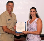 DAHLGREN, Va. - Vice Adm. William Hilarides, commander, Naval Sea Systems Command, presents the Navy Meritorious Civilian Service Award to Marie Colitti at an Aug. 11 awards ceremony. Hilarides congratulated Colitti and nine of her colleagues  - James Morrissett, Troy Bentz, Lorilee Geisweidt, Amanda Cardiel, Steven Sovine, Keith Manion, Meredith Murray, Jeffery McConnell and Christopher Knowlton - who also received the award for their impact on the Small Surface Combatant Task Force last year. "In response to the Secretary of Defense-directed study of a more lethal and more survivable small surface combatant, these recipients used their professional expertise to assist in the development of an extraordinary body of work that establishes the direction for a significant portion of the U.S. Navy shipbuilding and Force capability that reaches deep into this century," according to the citation. "The unassailable logic, method, and results that these recipients exhibited and applied to this task, provided the Department of the Navy and Department of Defense with the confidence it needs to make decisions of such high importance."  