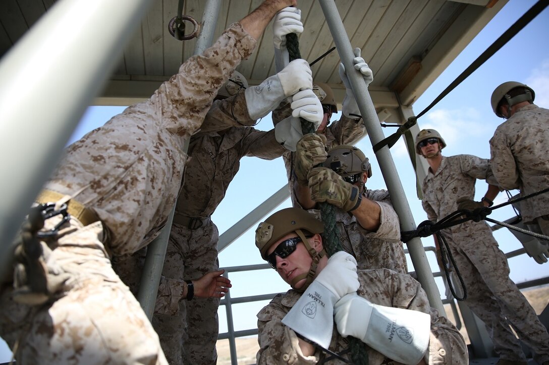 Marines assigned to Company A, 1st Reconnaissance Battalion, 1st Marine Division, prepare to fast-rope as a fire team aboard Marine Corps Base Camp Pendleton, Calif., Aug. 17, 2015. The Marines practiced fast-roping as a team to gain proficiency in order to effectively insert from a helicopter.