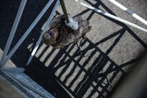 A Marine assigned to Company A, 1st Reconnaissance Battalion, 1st Marine Division, performs a lockout during Helicopter Rope Suspension Techniques training aboard Marine Corps Base Camp Pendleton, Calif., Aug. 17, 2015.  Practicing the lockout technique allows the Marines to stop on the rope rapidly in order to avoid landing in a potentially dangerous area.