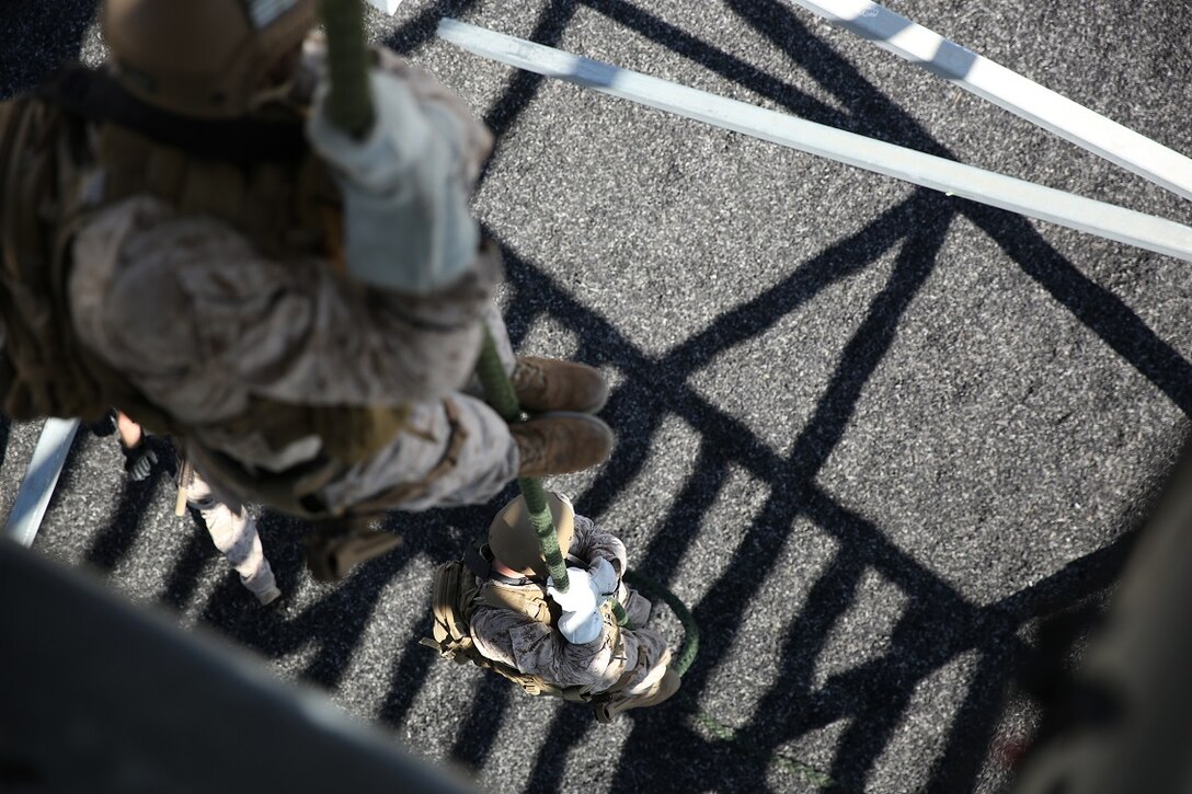 Marines assigned to Company A, 1st Reconnaissance Battalion, 1st Marine Division, fast-rope as a fire team aboard Marine Corps Base Camp Pendleton, Calif., Aug. 17, 2015. The Marines practiced fast-roping as a team to gain proficiency in order to effectively insert from a helicopter. (U.S. Marine photo by Cpl. Will Perkins)