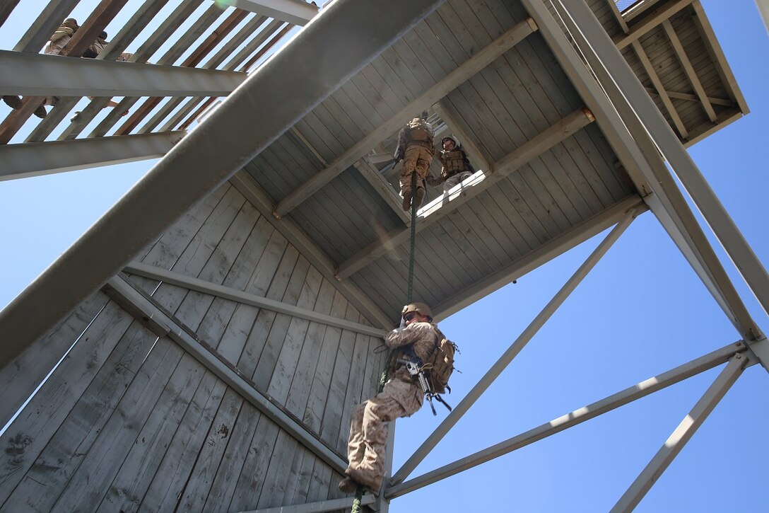 Marines assigned to Company A, 1st Reconnaissance Battalion, 1st Marine Division, fast-rope as a fire team aboard Marine Corps Base Camp Pendleton, Calif., Aug. 17, 2015. The Marines practiced fast-roping as a team to gain proficiency in order to effectively insert from a helicopter.