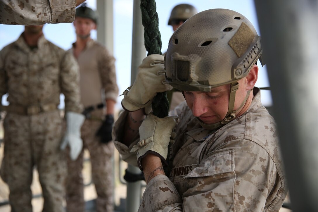 A Marine assigned to Company A, 1st Reconnaissance Battalion, 1st Marine Division, fast-ropes out of a tower as part of Helicopter Rope Suspension Techniques training to prepare for quick insertion missions out of helicopters aboard Marine Corps Base Camp Pendleton, Calif., Aug. 17, 2015. Fast-roping is the most commonly used insertion tactic for Reconnaissance Marines during training or real-life missions.