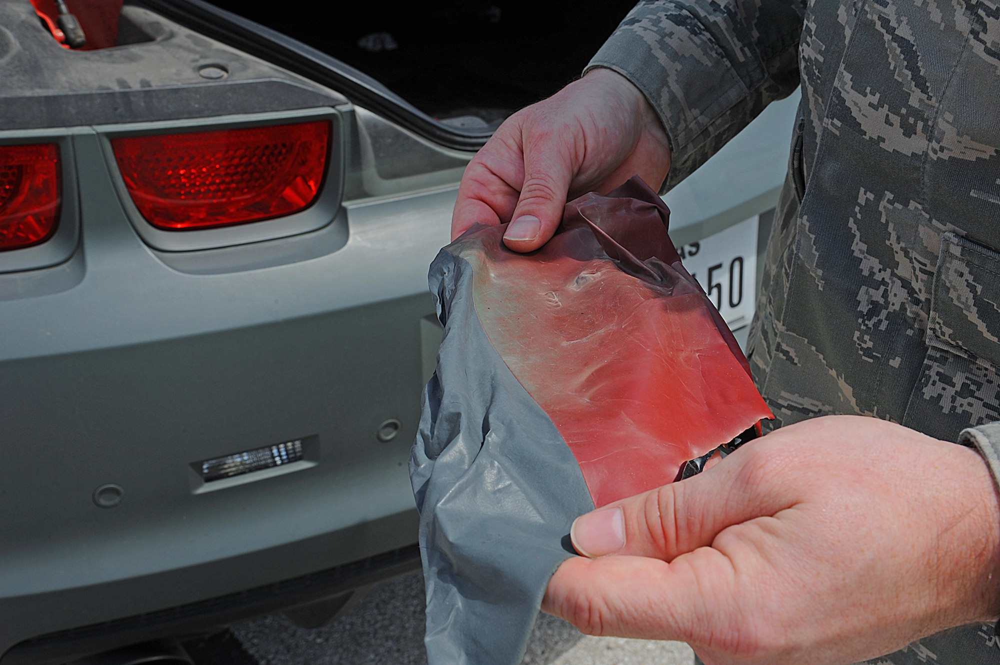 U.S. Air Force Tech. Sgt. Stephen Strong, 315th Training Squadron instructor, displays what the paint on his car looks like after being peeled off at Goodfellow Air Force Base, Aug. 18, 2015. Strong designs his own car by spraying on a type of paint that can peel off if he wishes to start over again. (U.S. Air Force photo by Airman Caelynn Ferguson/Released)