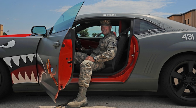 U.S. Air Force Tech. Sgt. Stephen Strong, 315th Training Squadron instructor, leans back in the driver seat of his Chevy Camaro at Goodfellow Air Force Base, Aug. 18, 2015. Strong painted his car on his own, designing both the interior and exterior after an old WWII P-40 Warhawk. (U.S. Air Force photo by Airman Caelynn Ferguson/Released)