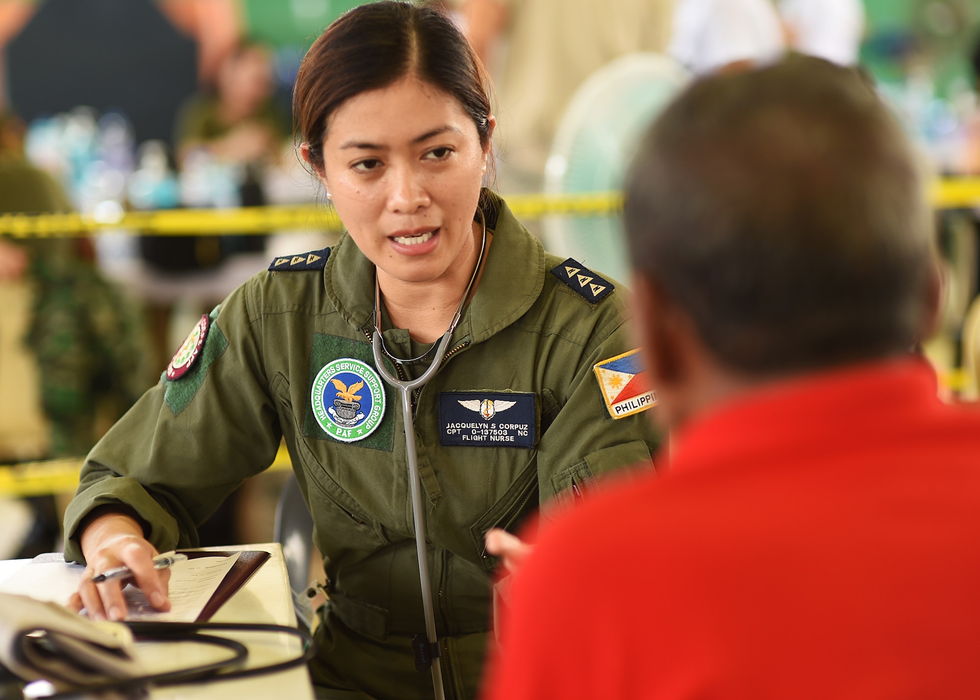 Philippine Air Force Capt. Jacquelyn Corpuz, a PAF flight nurse, questions a patient about his general heath during Pacific Angel’s healthcare services outreach, Bohol Province, Philippines, Aug. 16, 2015. The healthcare services outreach program provided general care, optometry services, dental care, physical therapy and a pharmacy. Pacific Angel is a multilateral humanitarian assistance civil military operation, which improves military-to-military partnerships in the Pacific while also providing medical health outreach, civic engineering projects and subject matter exchanges among partner forces.(U.S. Air Force photo by Tech. Sgt. Aaron Oelrich/Released)