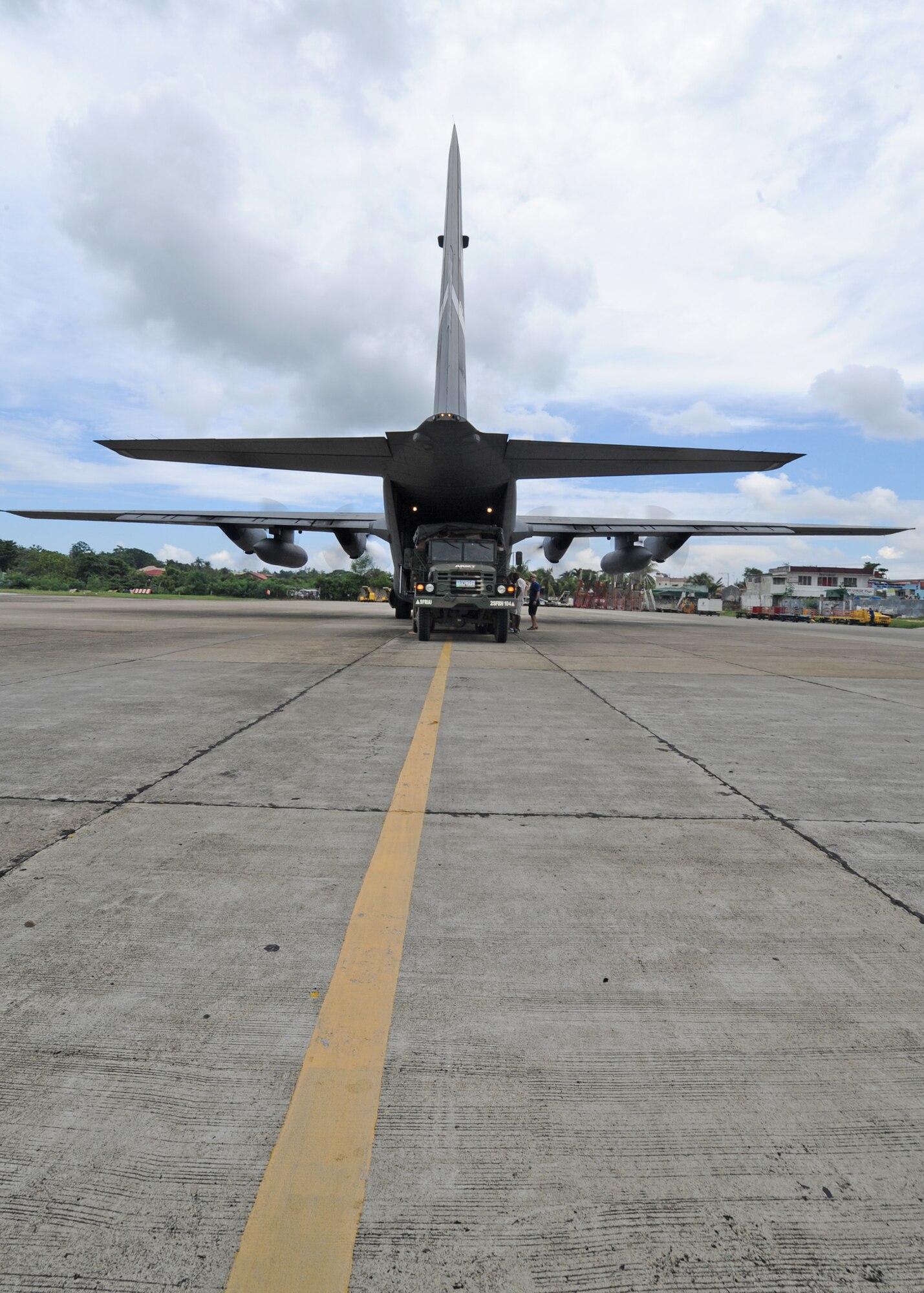 A U.S. Air Force C-130 Hercules from the Minnesota Air National Guard’s 133rd Airlift Wing is parked with engines running at the Tagbiliran Airport as Members of the Armed Forces of the Philippines and U.S. Military members transfer supplies to an Armed Forces of the Philippines vehicle in support of Pacific Angel Philippines at Tagbiliran, Philippines, Aug. 13, 2015. Pacific Angel is a multilateral humanitarian assistance civil military operation, which improves military-to-military partnerships in the Pacific while also providing medical health outreach, civic engineering projects and subject matter exchanges among partner forces.(U.S. Air Force photo by Tech. Sgt. Aaron Oelrich/Released)