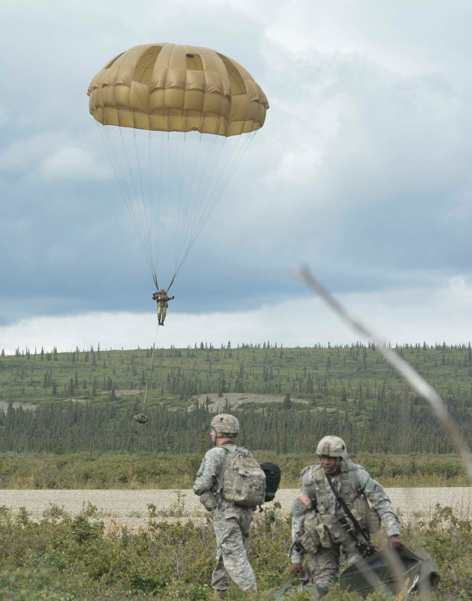 A Japan Ground Self-Defense Forces member from the 1st Airborne Brigade parachutes to the ground while 4th Brigade (Airborne), 25th Infantry Division paratroopers perform parachute recovery at Fort Greely, Alaska, Aug. 12. This event was part of Exercise Arctic Aurora 2015. (U.S. Army photo by Staff Sgt. Daniel Love)
