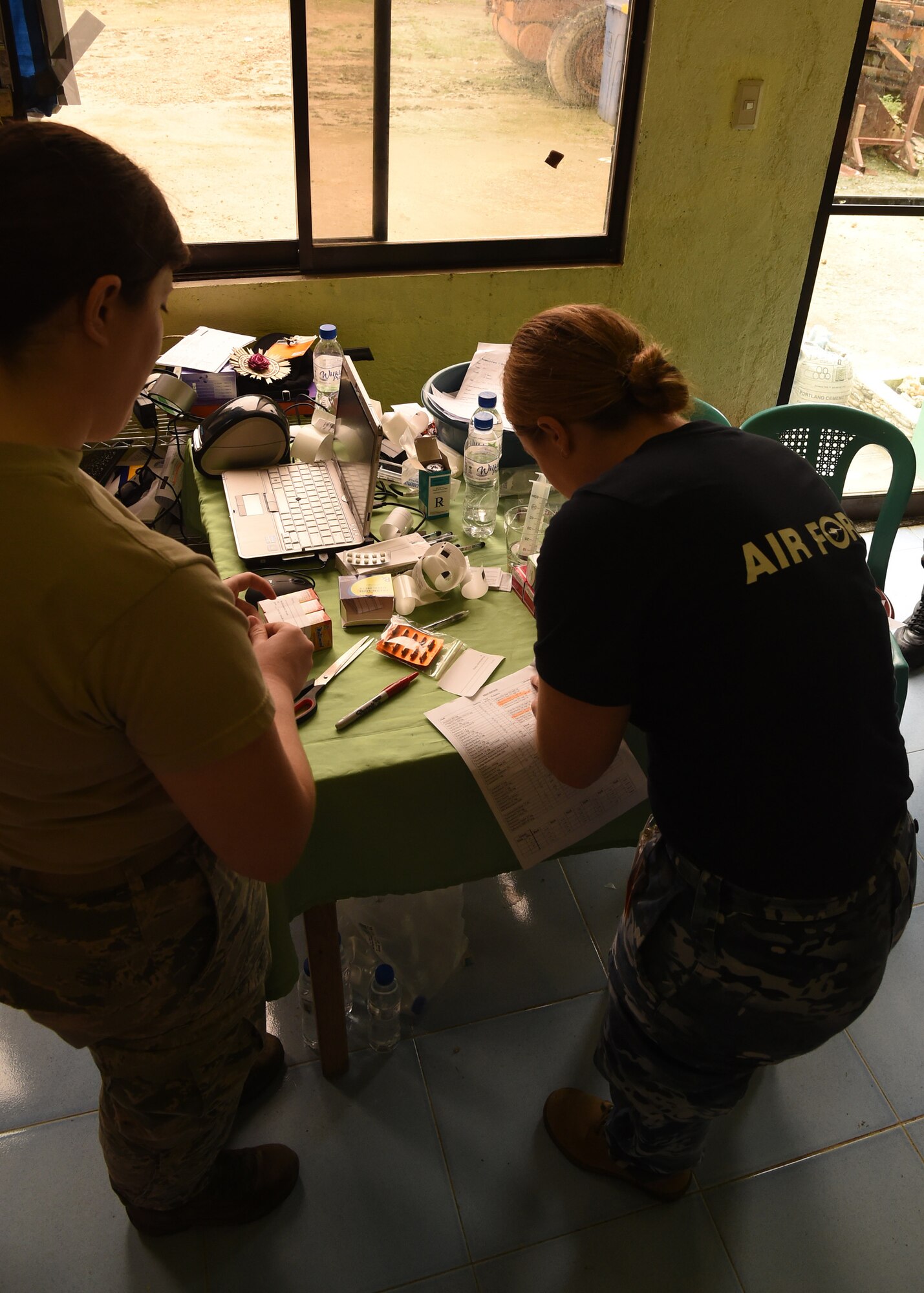 Royal Australian Air Force Flying Officer Kara Sellwood (right), a pharmacist, and U.S. Air Force Staff. Sgt Kristen Williams (left), a pharmacy technician from Andersen Air Force Base, Guam, prepare medication during the Health Services Outreach provided as part of the Pacific Angel Philippines mission taking place in Lila, Bohol province, Philippines, Aug. 16, 2015. Pacific Angel is a multilateral humanitarian assistance civil military operation, which improves military-to-military partnerships in the Pacific while also providing medical health outreach, civic engineering projects and subject matter exchanges among partner forces.(U.S. Air Force photo by Tech. Sgt. Aaron Oelrich/Released)