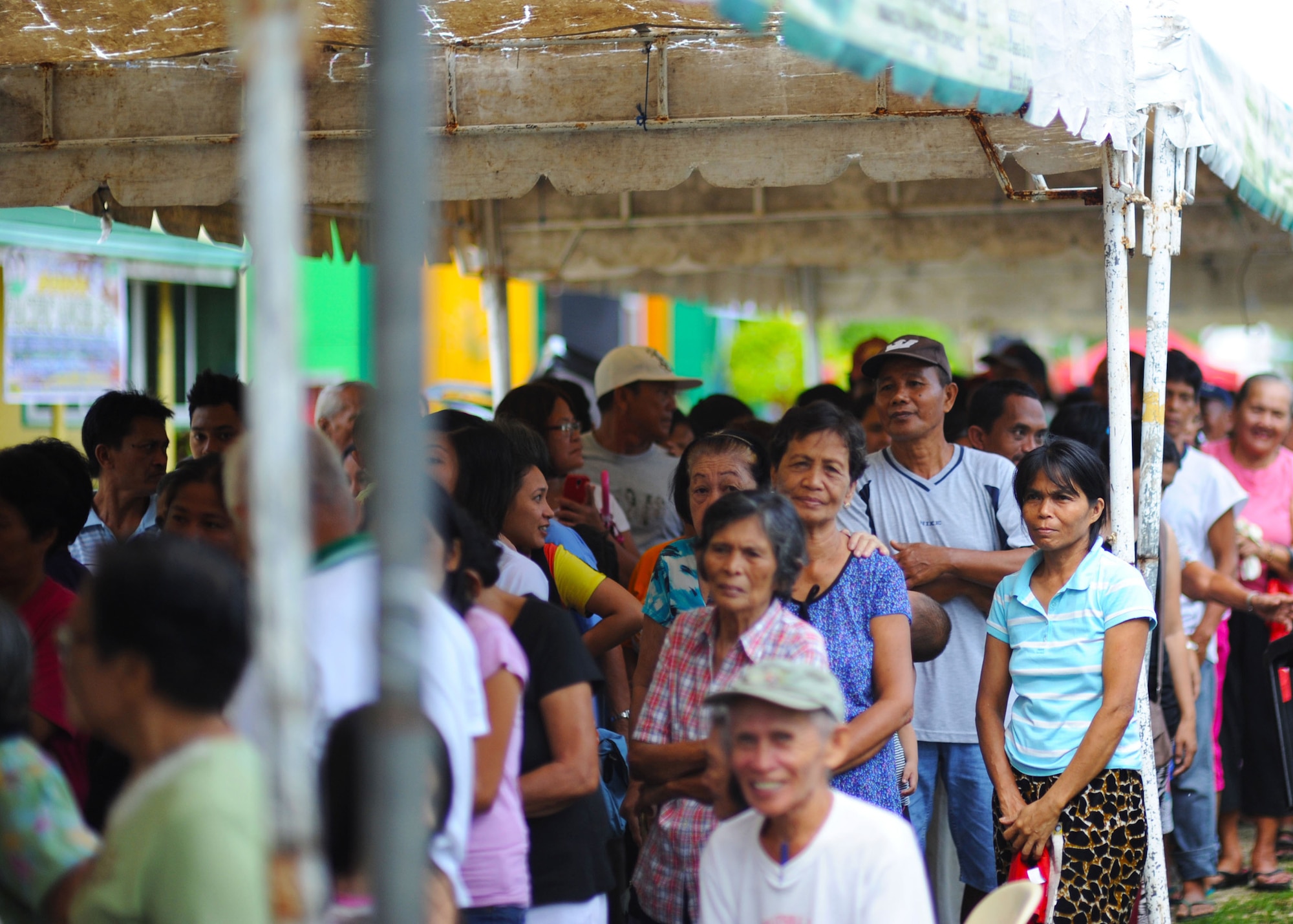 Citizens of Bohol province, Philippines, await their chance to see military doctors, dentists, optometrists, physical therapists and pharmacists from the U.S. Air Force, U.S. Army, U.S. Marine Corps and U.S. Navy along with service members from the Philippines, Australia, Indonesia, Timor-Leste and Papua New Guinea all supporting Pacific Angel Philippines in Lila, Bohol province, Philippines, Aug. 16, 2015. Pacific Angel is a multilateral humanitarian assistance civil military operation, which improves military-to-military partnerships in the Pacific while also providing medical health outreach, civic engineering projects and subject matter exchanges among partner forces. (U.S. Air Force photo by Tech. Sgt. Aaron Oelrich/Released)