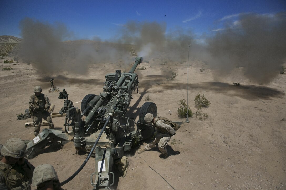 Marines with B battery, 1st Battalion, 10th Marine Regiment, provide support fire as part of Large Scale Exercise 15 in the vicinity of the Black Top Training Area, Aug. 15, 2015. The artillery fire supported a ground element during their assault on two objectives during the live-fire exercise. (Official Marine Corps photo by Cpl. Charles Santamaria/Released)