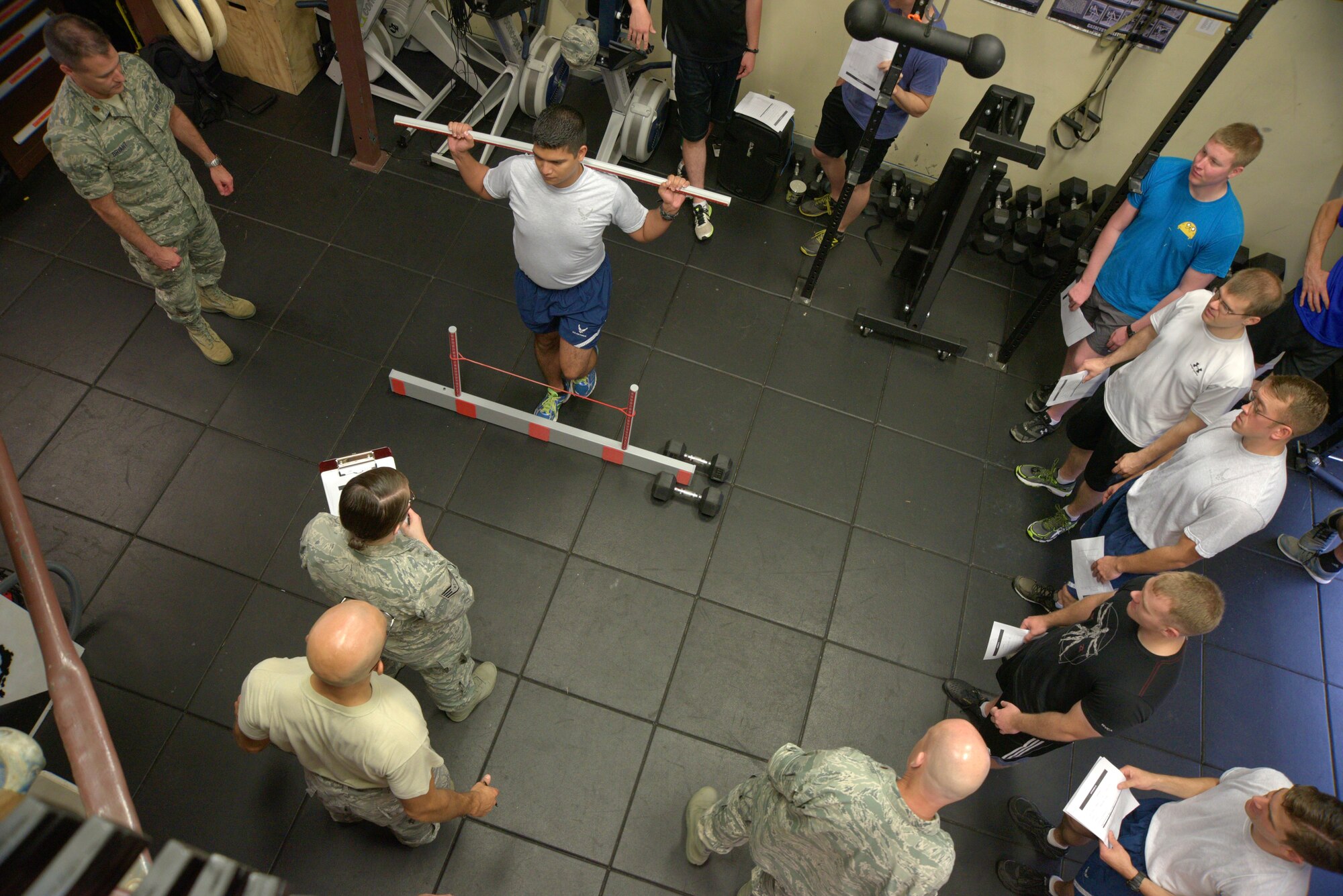 U.S. Air Force Airman 1st Class Manuel Carvajal, 35th Civil Engineer Squadron explosive ordnance disposal apprentice, is evaluated on his stability while performing a hurdle step during a functional movement screening at Misawa Air Base, Japan, Aug. 18, 2015. A score of zero to three was given for each screen, with zero indicating that pain was associated with movement the area being evaluated and a score of three being a normal diagnosis of the functional movement. (U.S. Air Force photo by Senior Airman Jose L. Hernandez-Domitilo/Released)