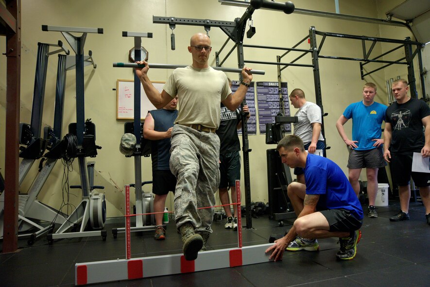 U.S. Air Force Maj. Gabriel Harris, 35th Medical Operations Squadron primary care flight commander, shows 35th Civil Engineer Squadron explosive ordnance disposal personnel how to perform a proper hurdle step at Misawa Air Base, Japan, Aug. 18, 2015. As part of a new initiative coined Operator Centered Medical Home, the medical team conducts needs assessments for units and develops specialized plans to address medical concerns within the unit. (U.S. Air Force photo by Senior Airman Jose L. Hernandez-Domitilo/Released)