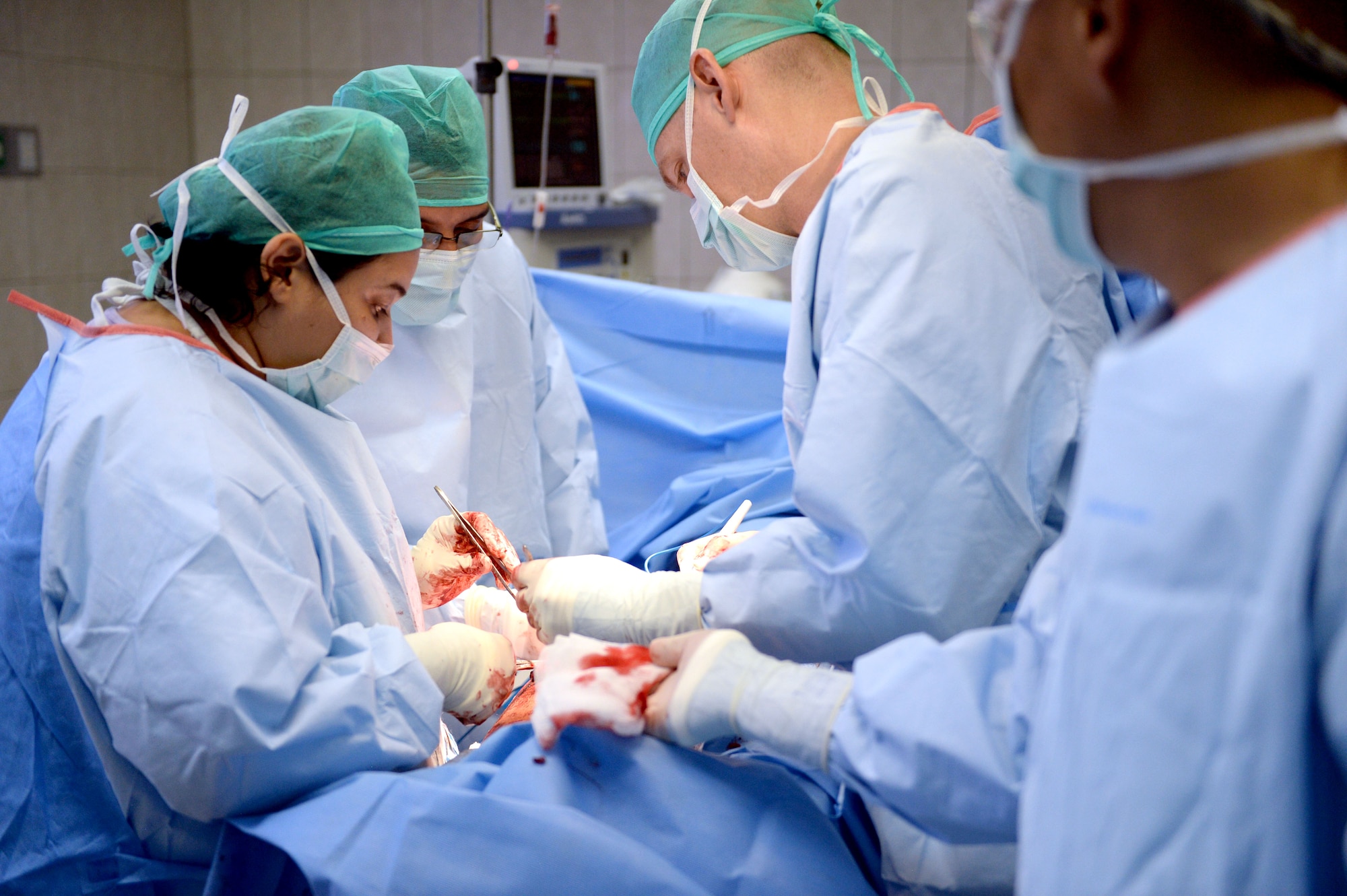 U.S. Air Force medical personnel work hand in hand with Honduran doctors to perform an emergency surgical procedure on a Honduran Army soldier with the 15th Battalion at the Dr. Salvador Paredes Hospital, August 10, 2015. The Honduran solider was one of 13 involved in an explosion at his base. The medical personnel are in Honduras as part of the New Horizons Honduras 2015 training exercise. 

New Horizons was launched in the 1980s and is an annual joint humanitarian assistance exercise that U.S. Southern Command conducts with a partner nation in Central America, South America or the Caribbean. The exercise improves joint training readiness of U.S. and partner nation civil engineers, medical professionals and support personnel through humanitarian assistance activities.

(U.S. Air Force photo by Capt. David J. Murphy/Released)