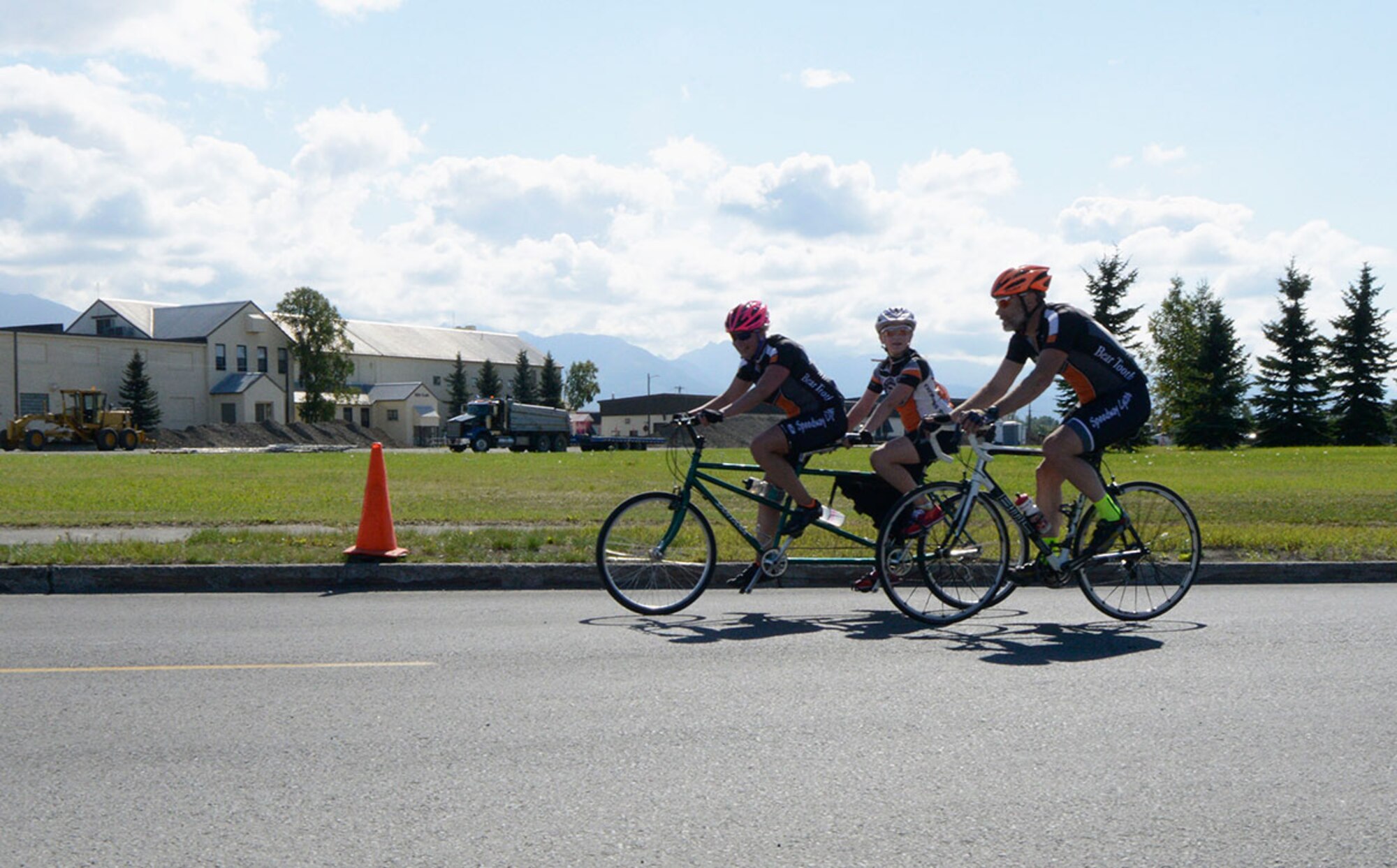 Members of the Beiergrohslein family cross the finish line of the 17-mile bike race on Joint Base Elmendorf-Richardson, Alaska, August 14, 2015. All the racers that took part in the event received a T-shirt. (U.S. Air Force photo/Airman Valerie A. Monroy)