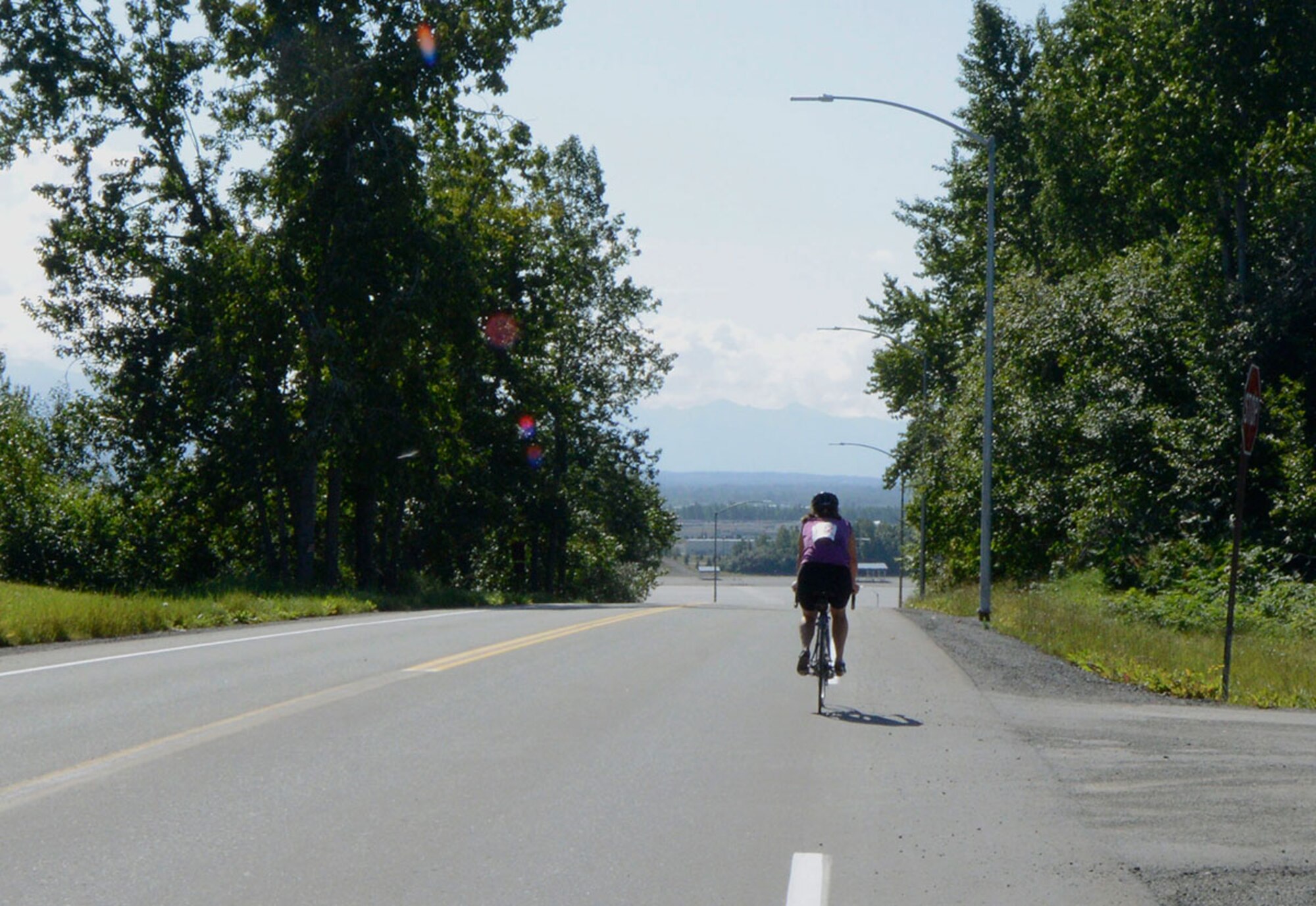 Lisa Ramstad, 673rd Civil Engineer Squadron, races forward on the path to finish the 17-mile bike race on Joint Base Elmendorf-Richardson, Alaska, August 14, 2015. Ramstad was awarded a prize for being the second female participant to finish the race. (U.S. Air Force photo/Airman Valerie A. Monroy)