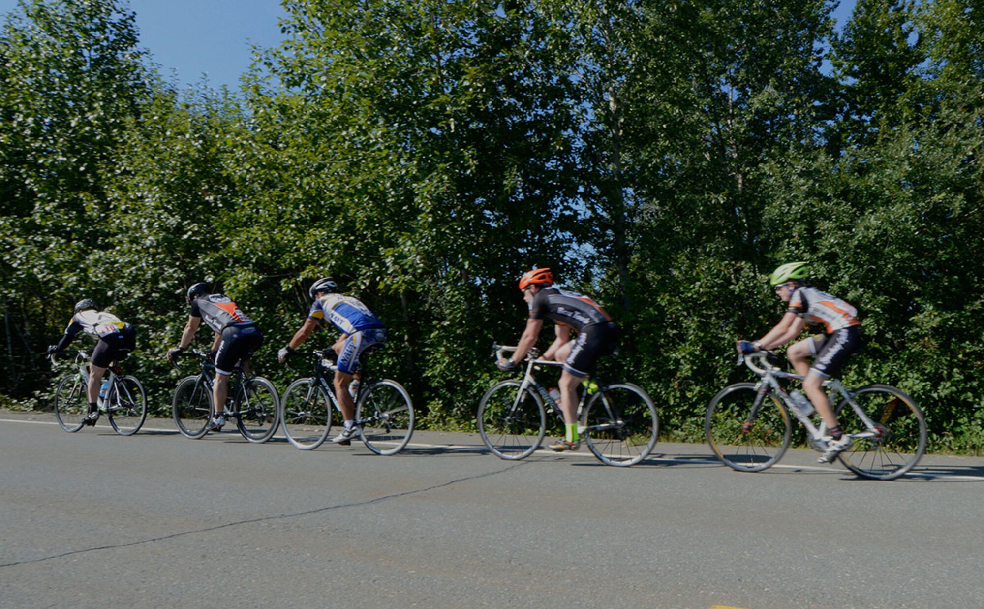 Participants race along the side of the street during the 17-mile bike race on Joint Base Elmendorf-Richardson, Alaska, August 14, 2015. Air Force Master Sgt. Michael Hancock, 176th Air Defense Squadron, and Tech. Sgt. Paul Hosmanek, 773rd Civil Engineer Squadron, were the top two males to finish the race. (U.S. Air Force photo/Airman Valerie A. Monroy)