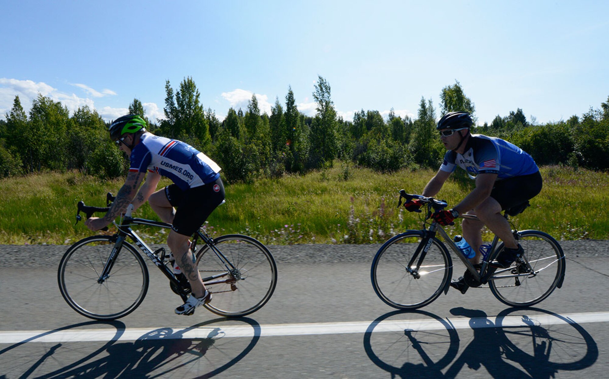 Air Force Master Sgt. Steven Cherry, 176th Maintenance Group, catches up to another participant in the 17-mile bike race on Joint Base Elmendorf-Richardson, Alaska, August 14, 2015. Prizes were awarded to the top two male and female performers.  (U.S. Air Force photo/Airman Valerie A. Monroy)