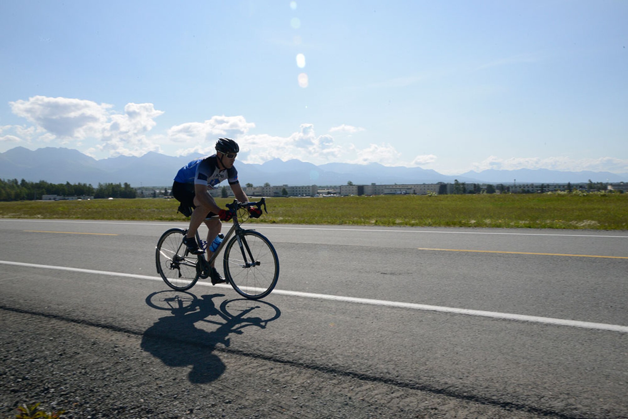 Air Force Master Sgt. Steve Cherry, 176th Maintenance Group, races forward on the path of the 17-mile bike race on Joint Base Elmendorf-Richardson, Alaska, August 14, 2015. The event was hosted by the Elmendorf Fitness Center on JBER. (U.S. Air Force photo/Airman Valerie A. Monroy)