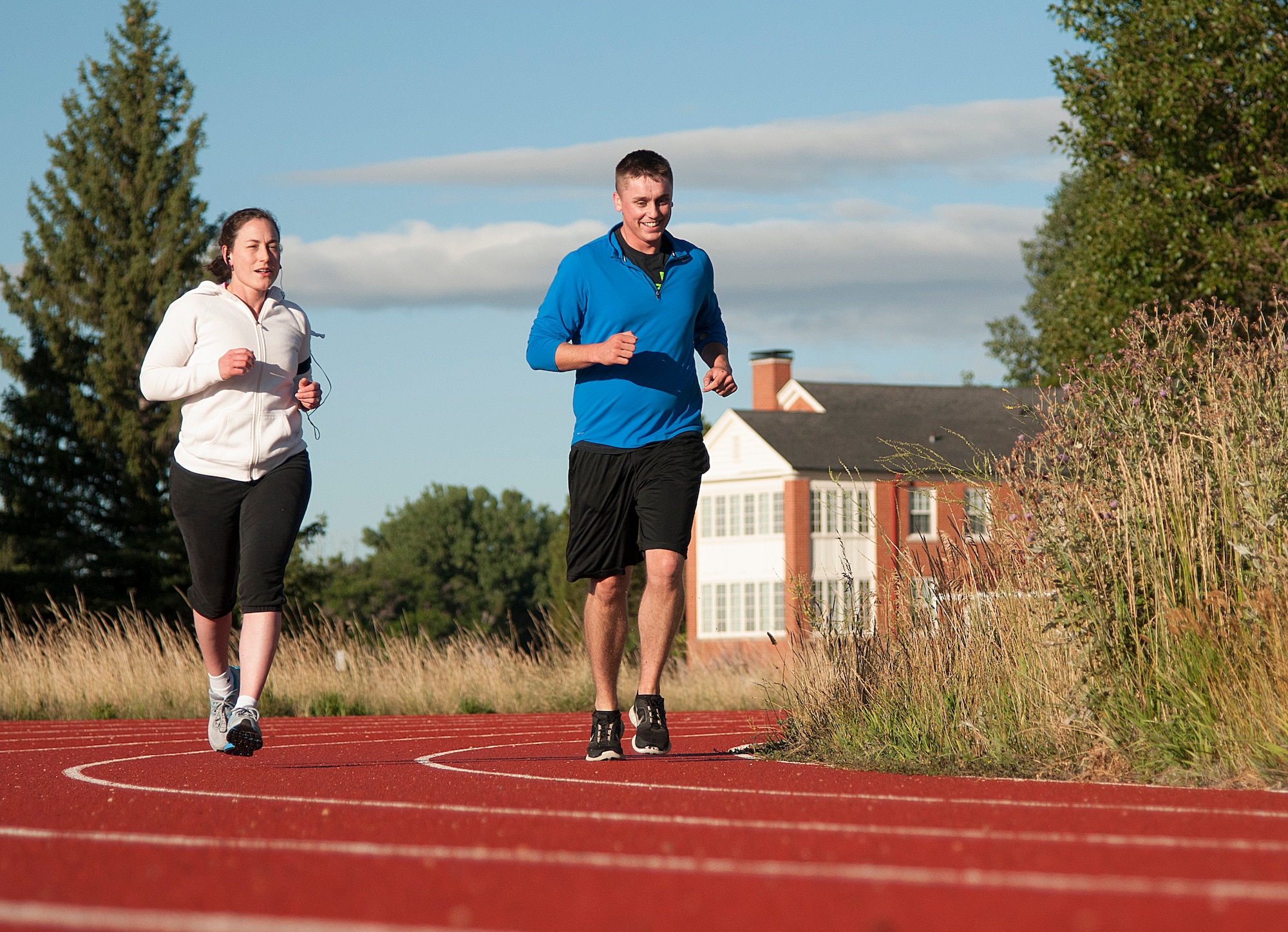 Staff Sgt. Sarah Cox and Airman 1st Class Austin Langlois, 90th Medical Operations Squadron Bioenvironmental Engineering technicians, run on a track on F.E. Warren Air Force Base, Wyo., Aug. 19, 2015. Exercise is recommended by health experts, but over-exertion can lead to a painful condition called Rhabdomyolysis, which is the build up of intracellular material in the blood from damaged muscle tissue. (U.S. Air Force photo by Senior Airman Jason Wiese)
