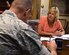 Lorri Welsh, 90th Missile Wing Protocol chief, briefs Col. Stephen M. Kravitky, 90th MW commander, Aug. 11, 2015, in his office on F.E. Warren Air Force Base, Wyo., on the up-coming visit of the deputy chairman of the joint chief of staff to F.E. Warren. The protocol office is in charge of providing behind the scenes support for formal ceremonies and distinguished visitor trips. (U.S. Air Force photo by R.J. Oriez)