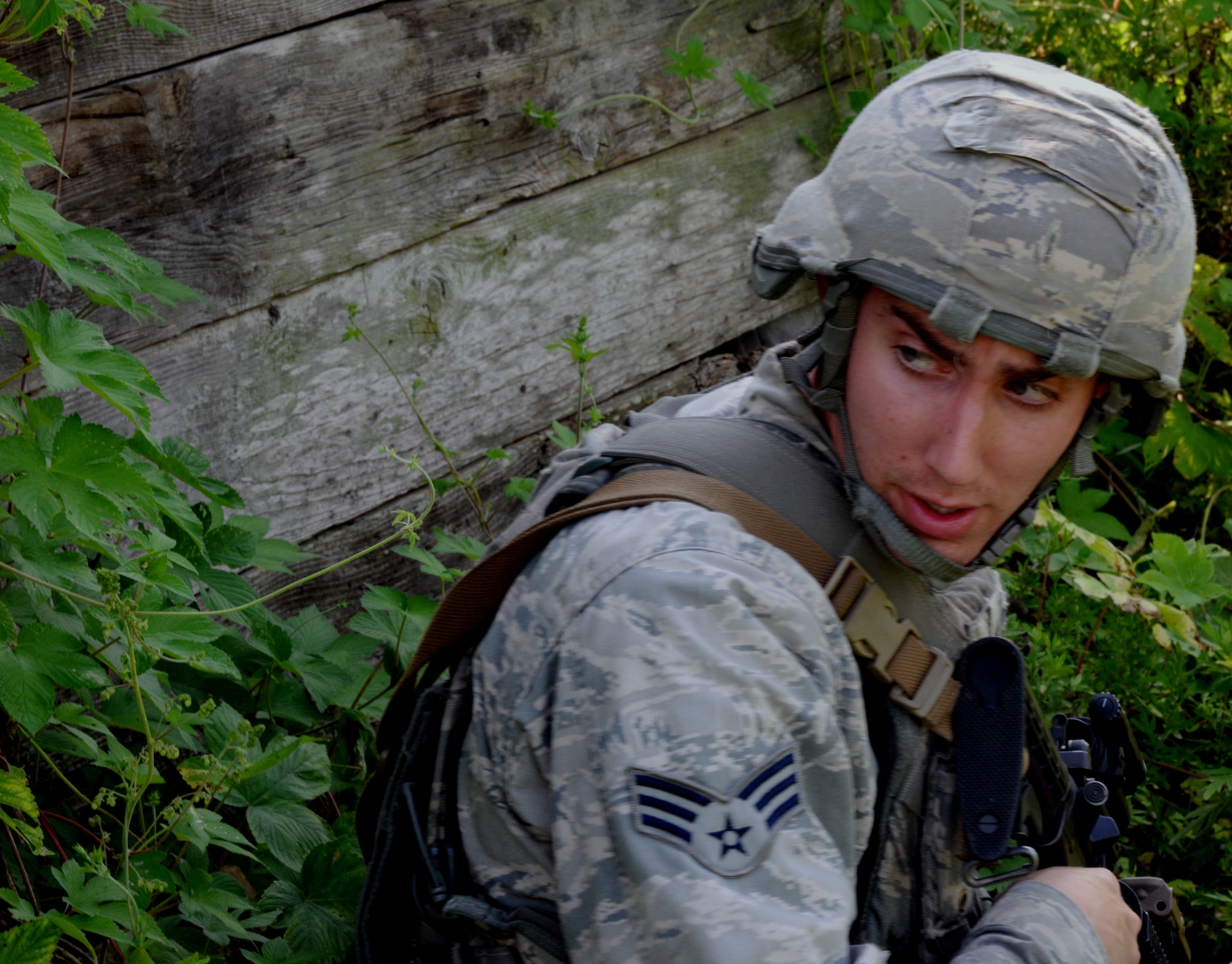 Senior Airman Cody Hooker, 51st Security Forces Squadron patrolman, looks behind himself before continuing an exercise patrol Aug. 18, 2015, near Pyeongtaek, South Korea. Members of the 51st SFS and Republic of Korea Army worked together to perform multiple patrols during the simulated exercise in an effort to bolster combat readiness. (U.S. Air Force photo by Staff Sgt. Benjamin Sutton) 